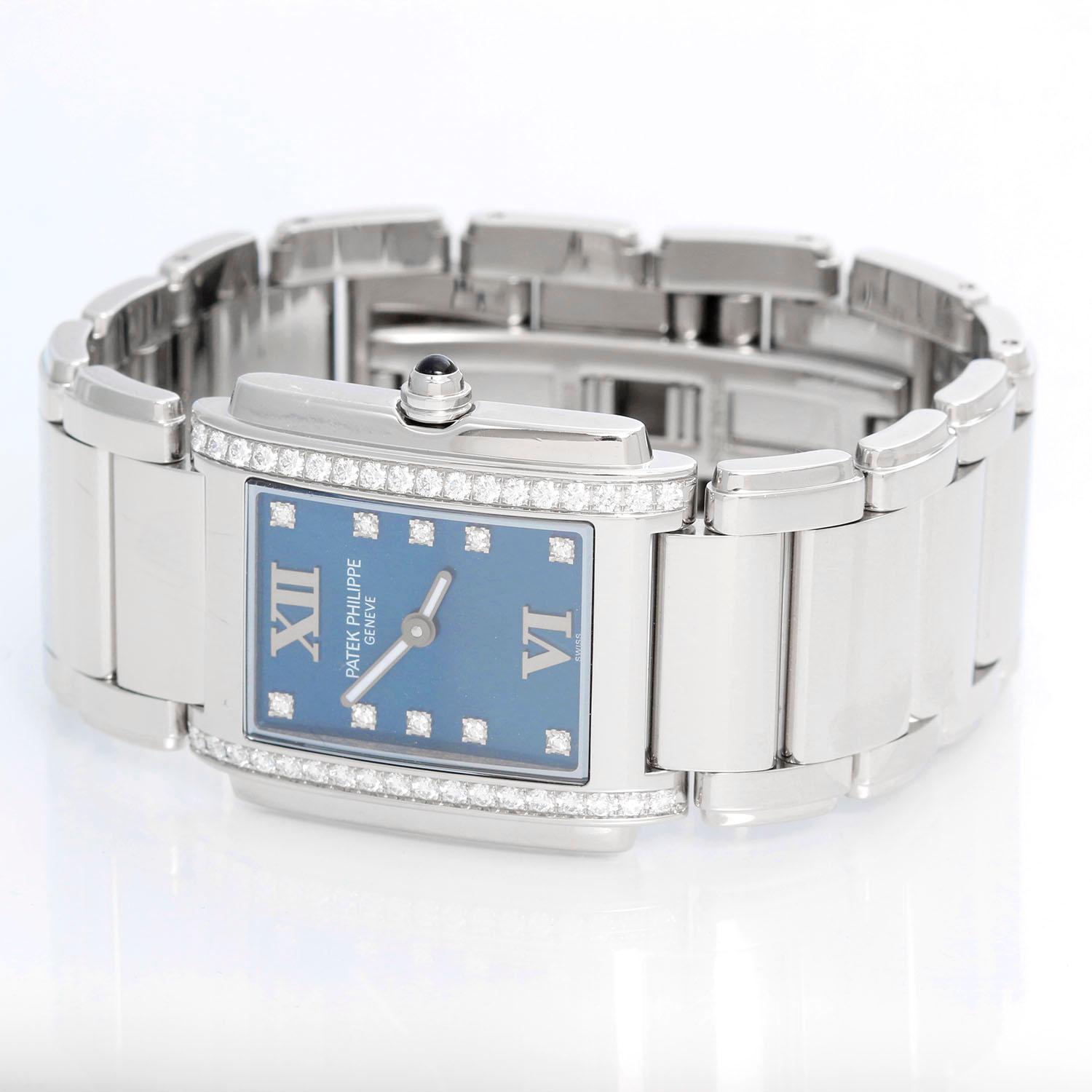 Ladies Patek Philippe Twenty-4 Watch Stainless Steel Blue Dial Watch 4910/10A - Quartz. Stainless steel case with diamond bezel (25mm x 30mm). Blue dial with diamond markers and Roman numerals at 12 & 6. Stainless steel Patek Philippe link bracelet.