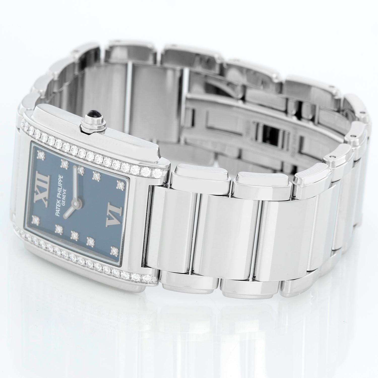 Ladies Patek Philippe Twenty-4 Watch Stainless Steel Blue Dial Watch 4910/10A - Quartz. Stainless steel case with diamond bezel (25mm x 30mm). Blue dial with diamond markers and Roman numerals at 12 & 6. Stainless steel Patek Philippe link bracelet;