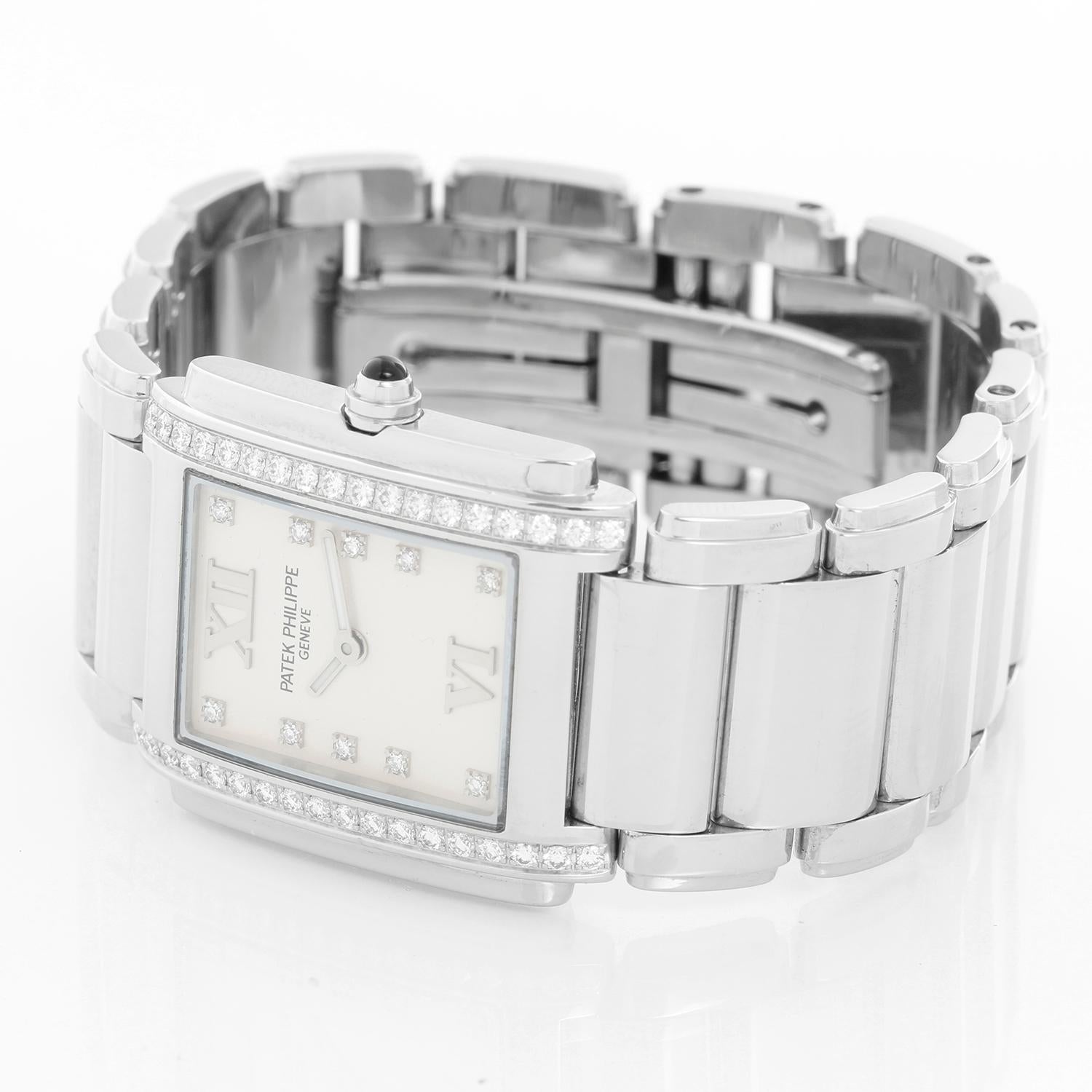 Ladies Patek Philippe Twenty-4 Watch Stainless Steel White Dial Watch 4910/10A - Quartz. Stainless steel case with diamond bezel (25mm x 30mm). White dial with diamond markers and Roman numerals at 12 & 6. Stainless steel Patek Philippe link