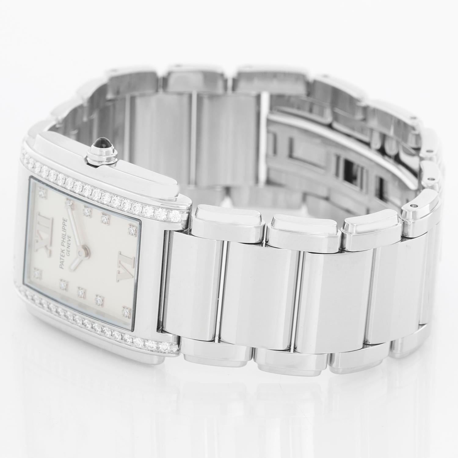 Ladies Patek Philippe Twenty-4 Watch Stainless Steel White Dial Watch 4910/10A - Quartz. Stainless steel case with diamond bezel (25mm x 30mm). White dial with diamond markers and Roman numerals at 12 & 6. Stainless steel Patek Philippe link