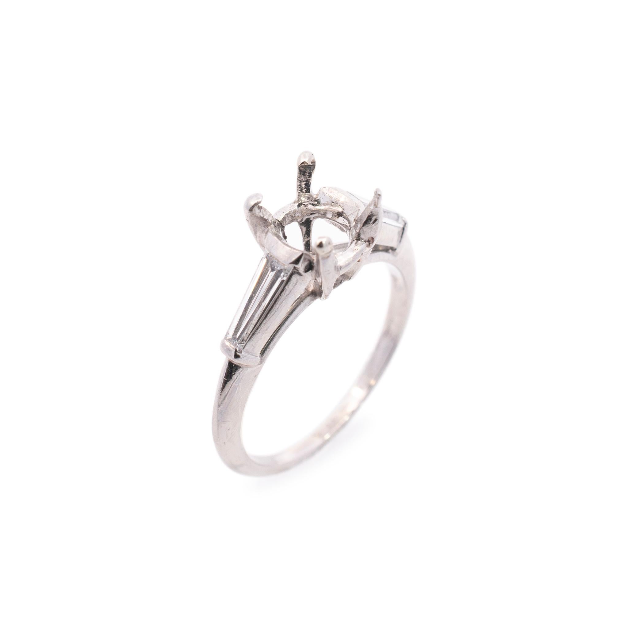 One lady's custom made polished platinum, diamond engagement, semi-mount ring with a half round shank. The ring is a size 5.5. The ring weighs a total of 4.00 grams. Engraved with 