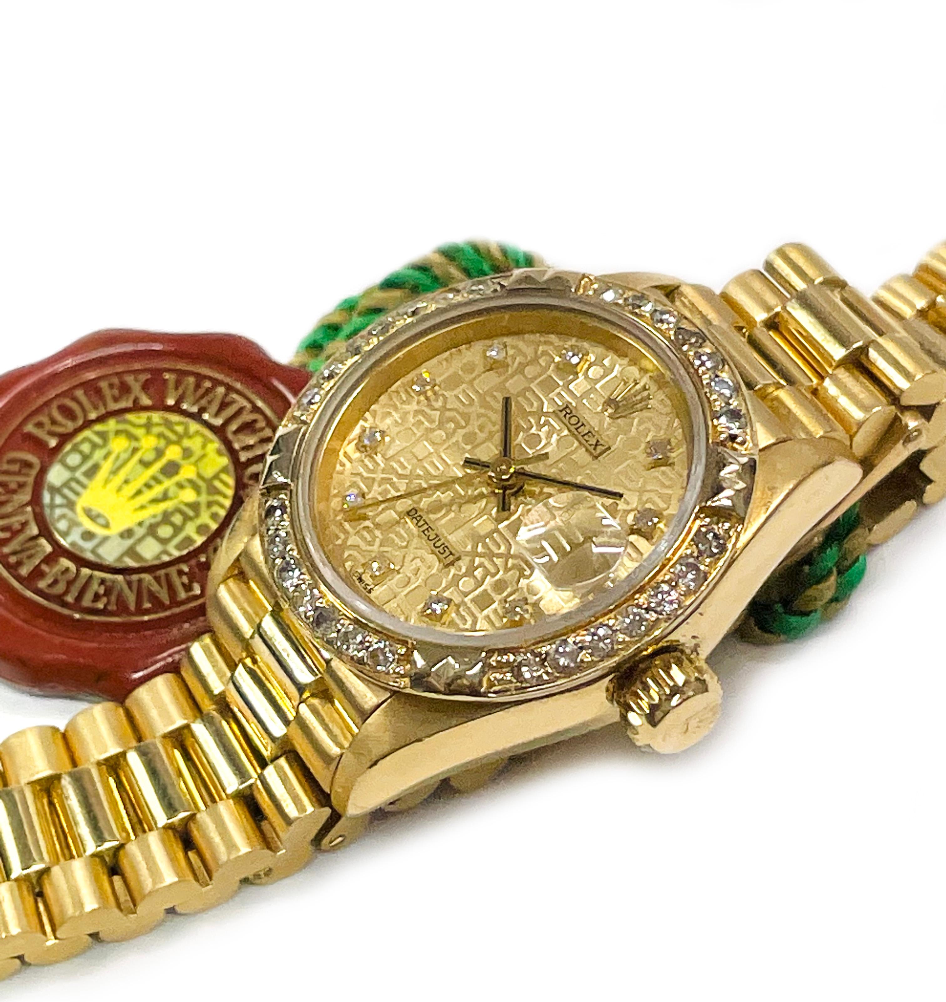 18 Karat Ladies Rolex Anniversary Datejust Diamond Bezel Watch. Stunning wristwatch with a gold dial, gold hour, minute, and second hand, diamond hours (except for the 12th hour), and diamond bezel. The ROLEX name is in a repeat pattern on the dial.