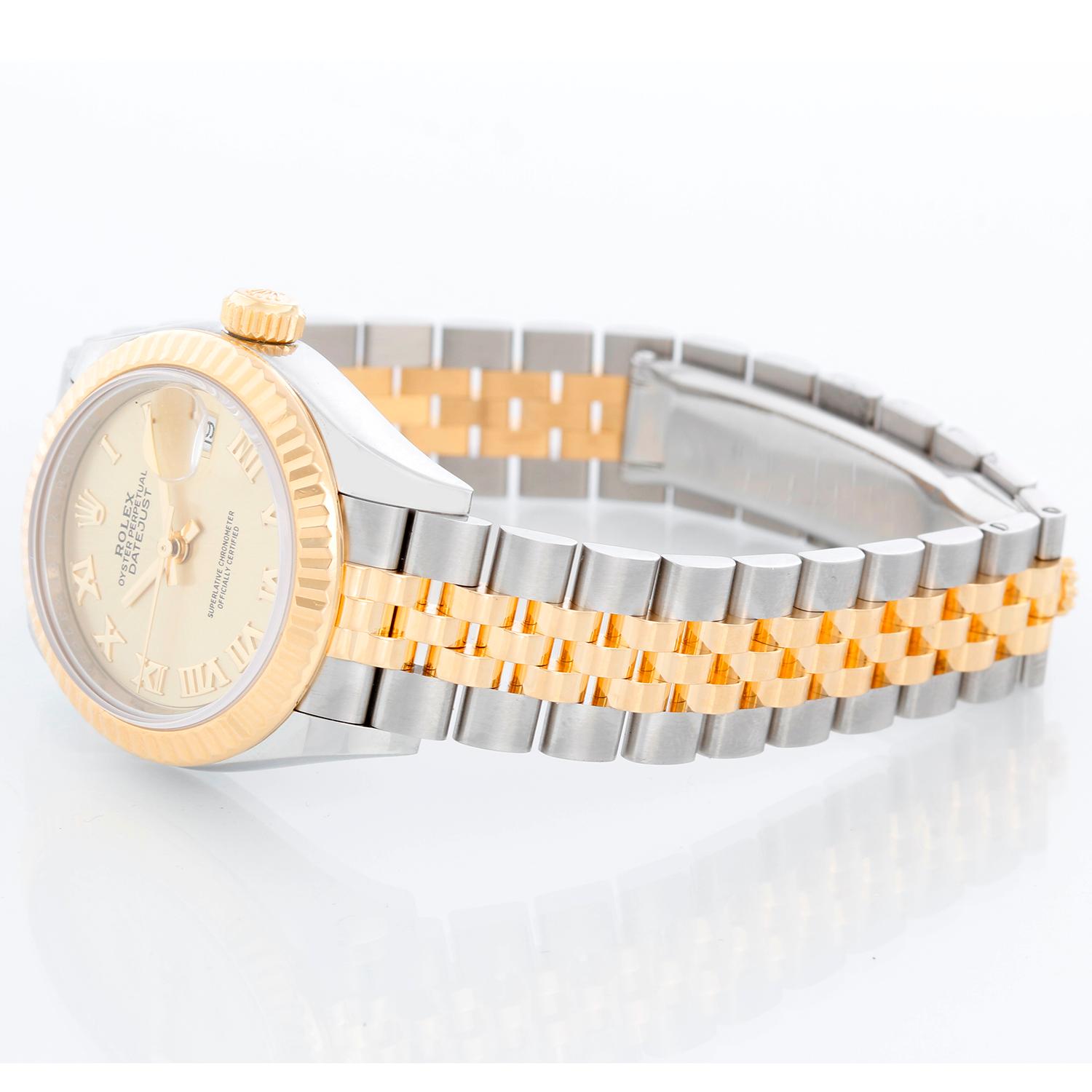 Ladies Rolex Datejust 28mm 18K Yellow Gold and Stainless Steel 279173 - Automatic winding, 31 jewels, Quickset date, sapphire crystal. 18K Yellow gold and Stainless Steel ( 28 mm). Champagne Roman dial. Two-Tone Jubilee bracelet. Pre-owned with