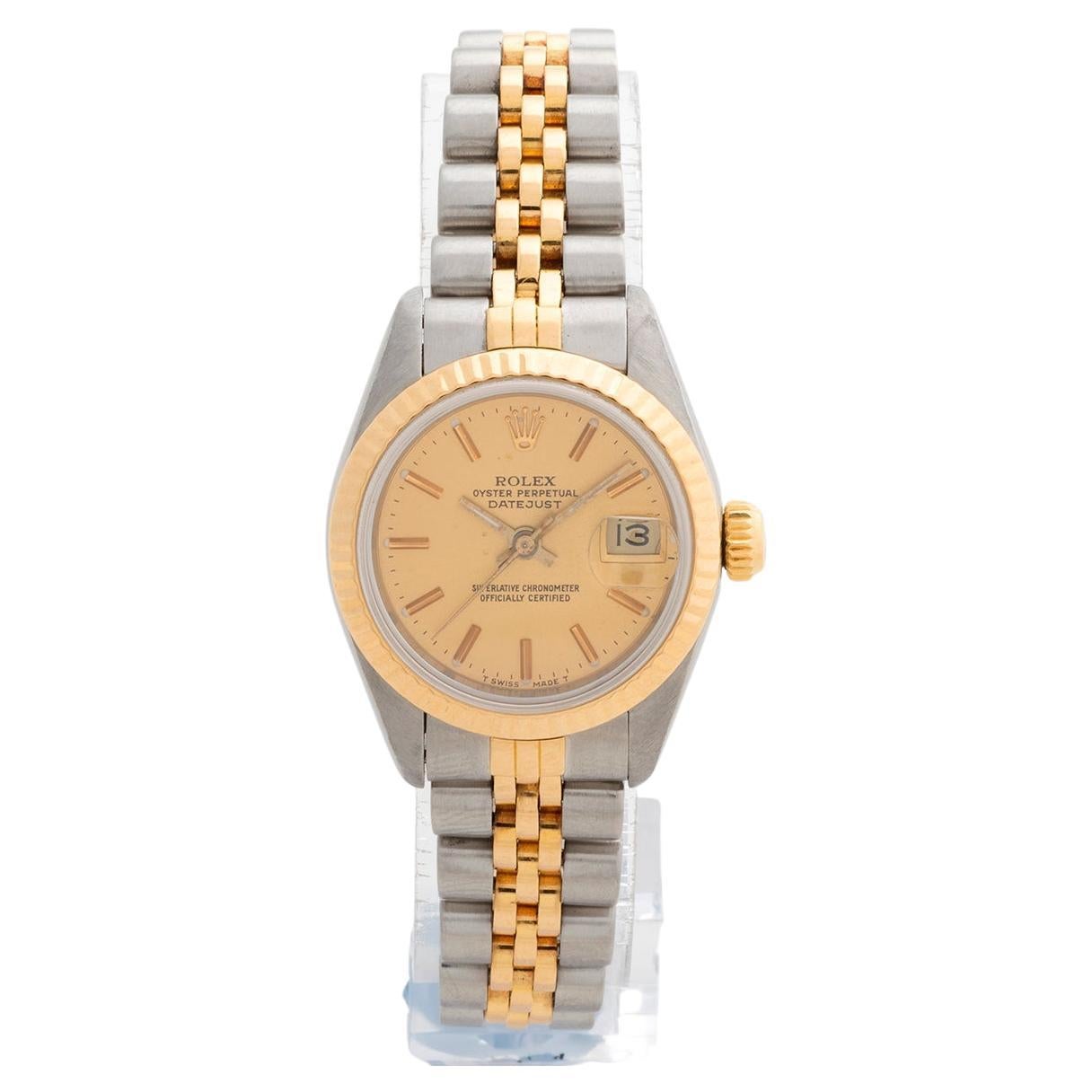 Our neo vintage ladies Rolex Datejust reference 69173 features a stainless steel case (with fluted 18k yellow gold bezel), a lightly patinated champagne dial and 18k yellow gold and stainless steel jubilee bracelet. We date production of this lady