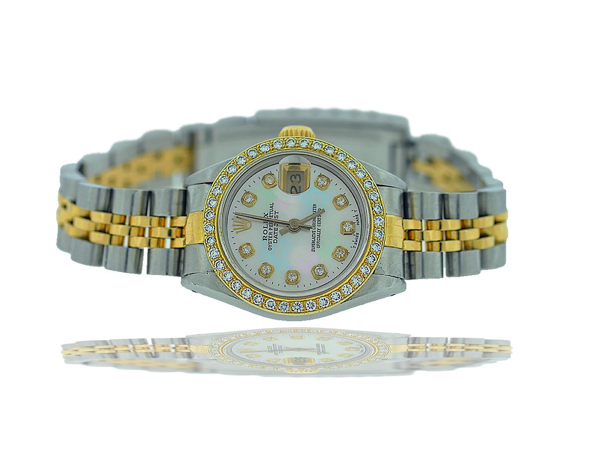 This ladies diamond Rolex is a gorgeous example of a classic timepiece.  Vintage Rolex Lady Datejust 26MM Stainless Steel and Yellow Gold. 26mm stainless steel case, with a yellow gold screw down crown with Rolex Motif. Aftermarket yellow gold