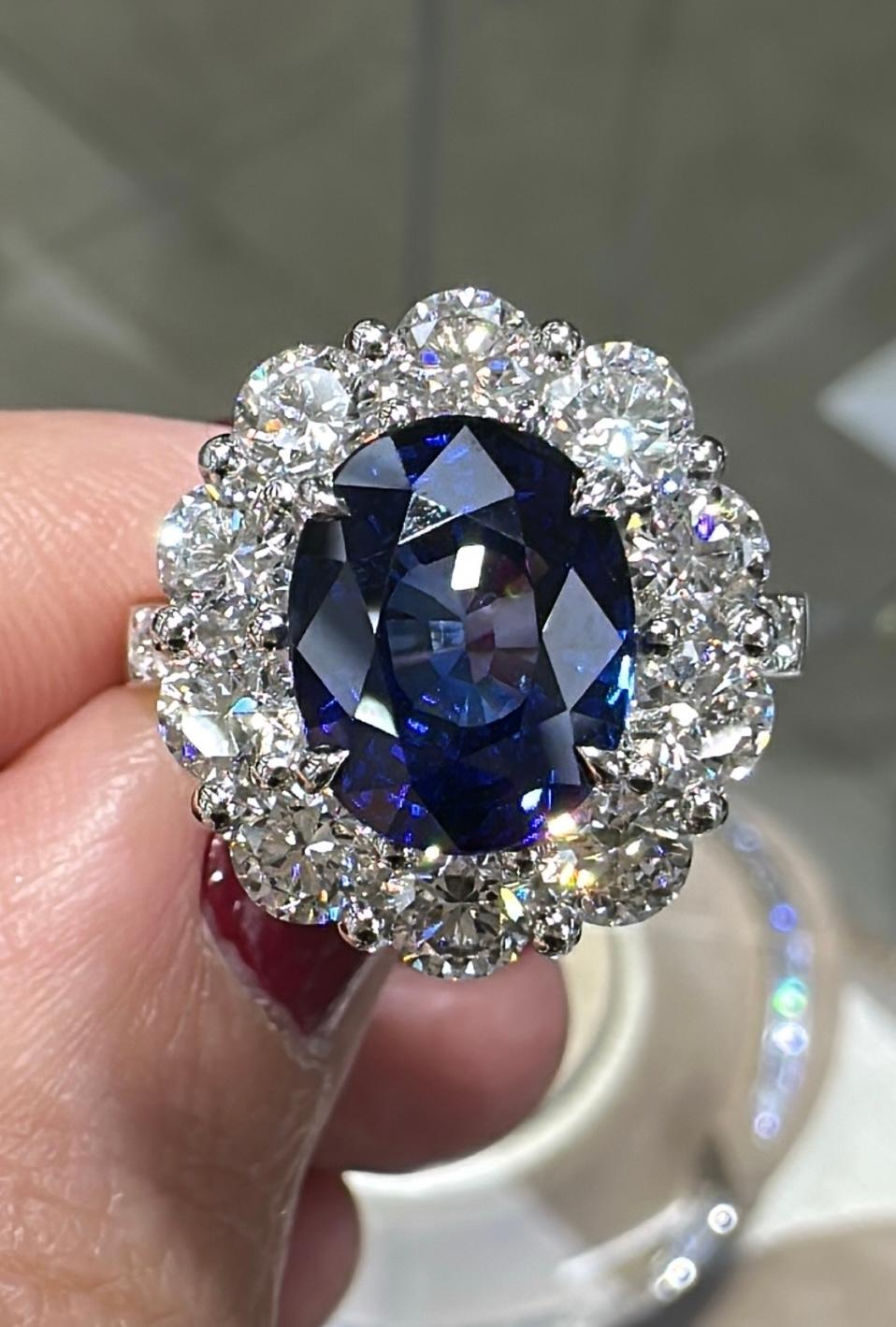 Blue sapphire statement cocktail ring is a great way to create an elegant, princess-like look.
The center stone is oval in shape and has gorgeous facets. For extra sparkle, it has been framed by 1.34 round diamonds forming a beautiful halo around
