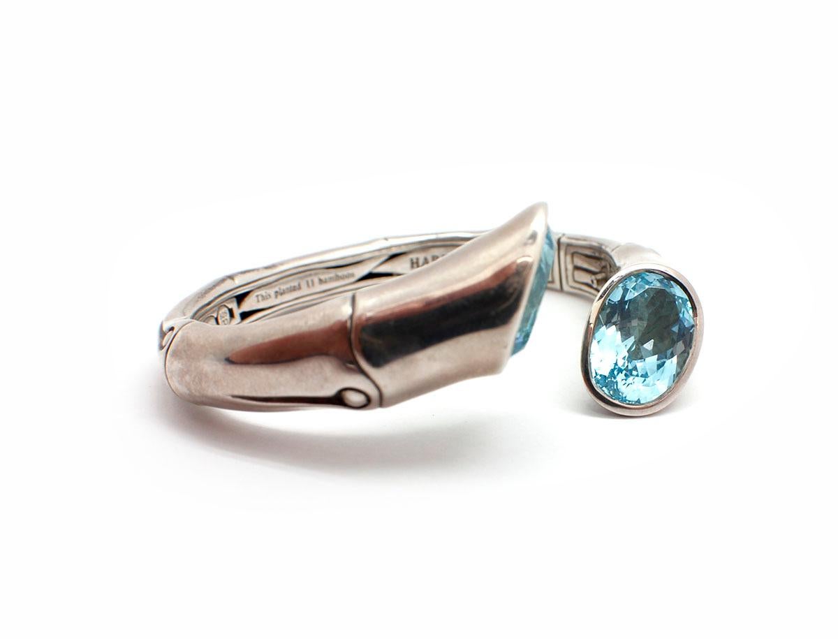 This amazing John Hardy cuff bracelet is crafted in sterling silver. The bracelet is set with 2 large Swiss blue topaz. The cuff has a hinged opening for easier applicability and is stamped 