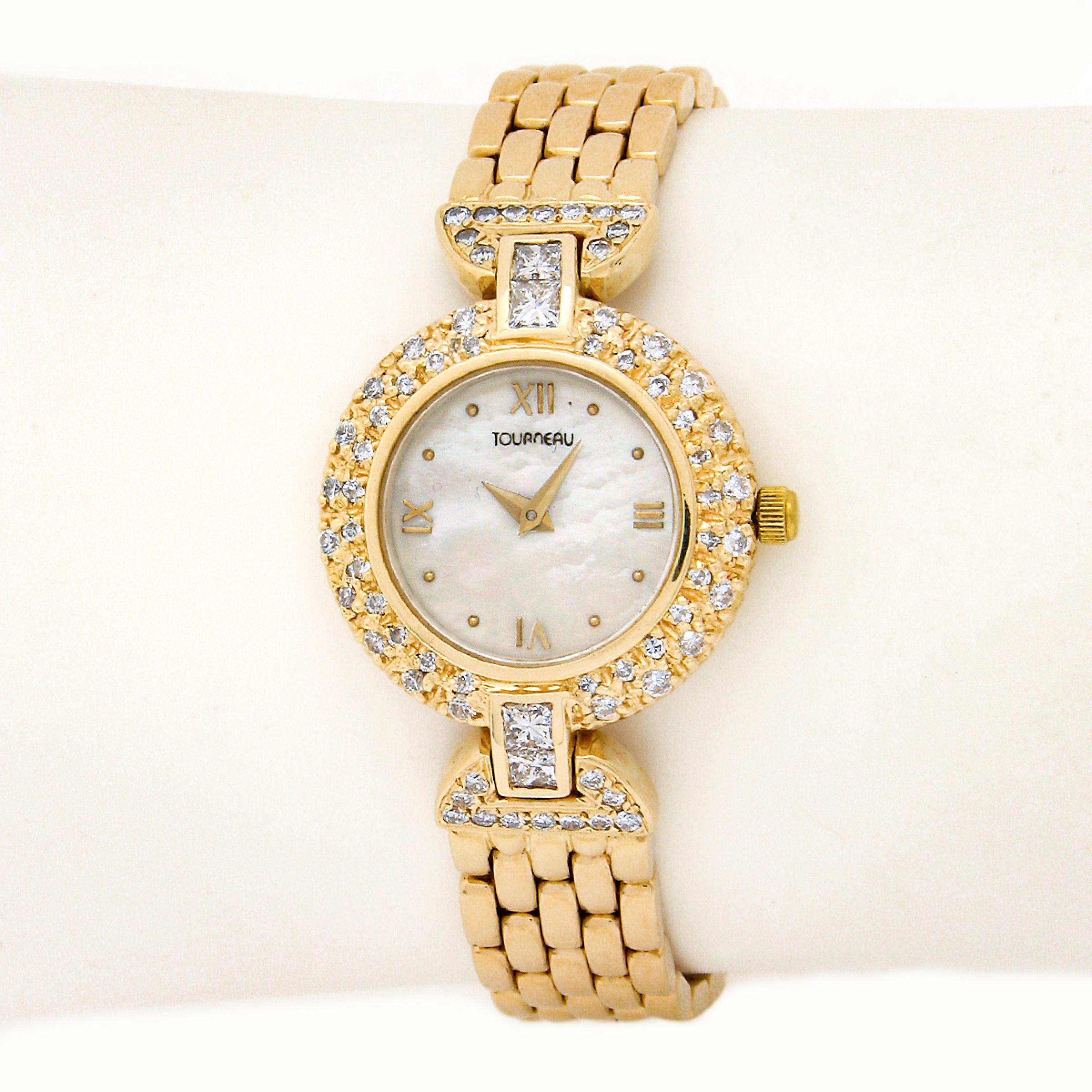 This fancy and super elegant ladies' wrist watch by Tourneau is completely crafted from solid 14k yellow gold. It features a lovely mother of pearl dial and a 22.3mm round shaped case that is adorned with the round brilliant cut diamonds and are