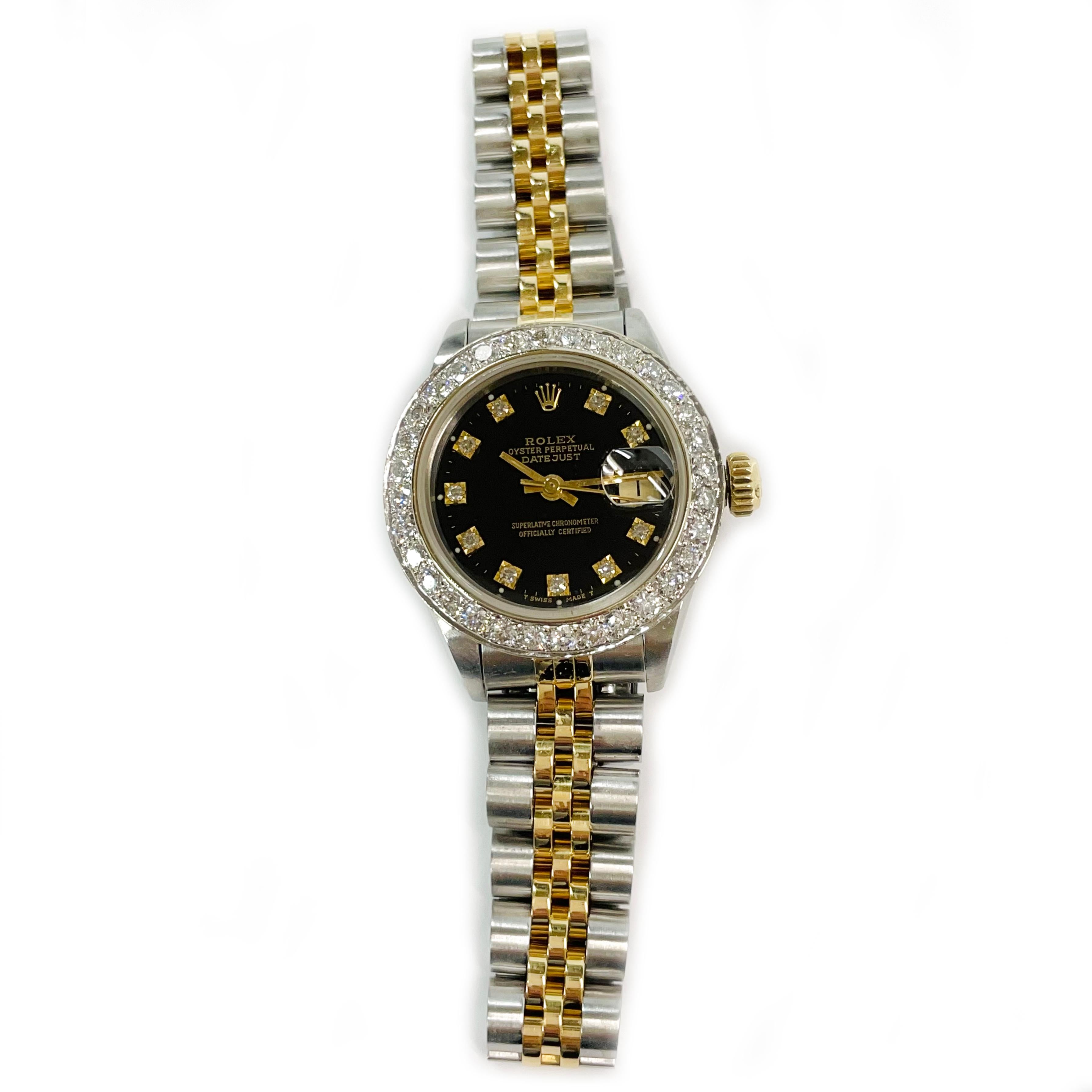 Ladies Two-Tone Rolex Oyster Perpetual Datejust Diamond Bezel Wristwatch. Exquisite wristwatch with a black dial, gold hour, minute, and second hand, diamond hours, and diamond bezel. There are thirty-two 2.1mm round pave-set diamonds set on the