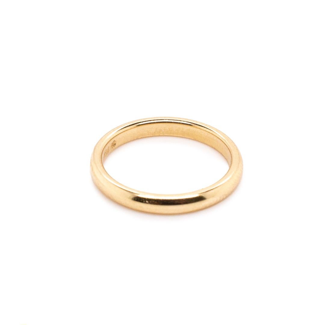 One lady's custom made polished 14K yellow gold, solitaire, wedding, matching wedding band with a half-round shank. The band is a size 5 and is 2.50mm thick. The band weighs a total of 2.40 grams. Engraved with 