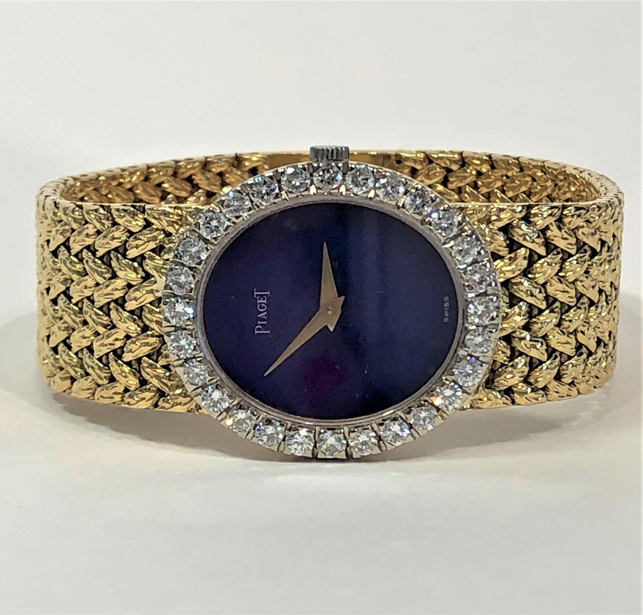 This lovely 18k Yellow Gold Ladies Piaget has a vertical oval, lapis lazuli dial surrounded by 28 
round brilliant cut diamonds weighing an approximate total of 1.80CT of overall E/F Color and
VS1 Clarity. The integral woven mesh band measures just