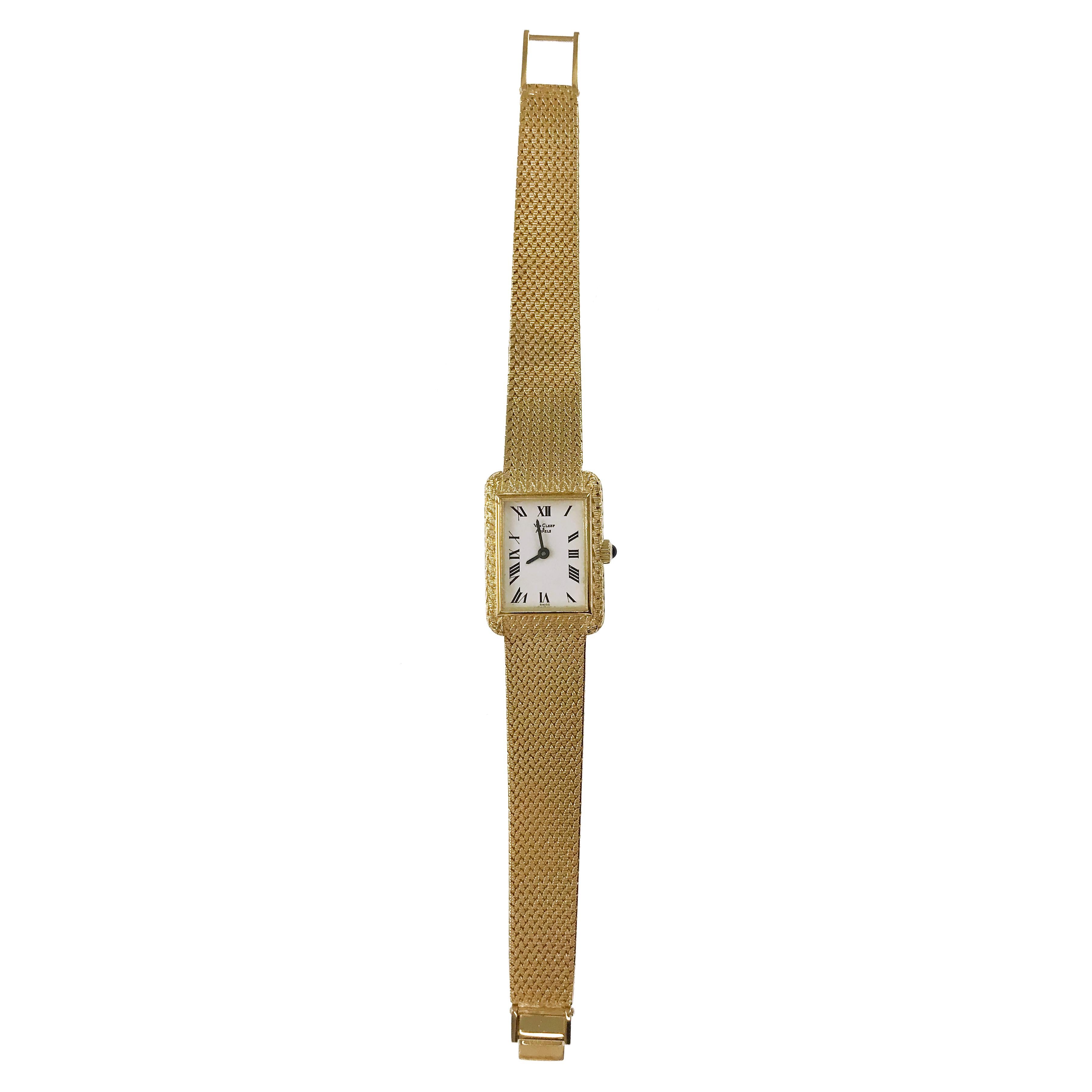 Ladies Vintage 14 Karat Van Cleef & Arpels Watch. The rectangular-faced dial is framed in a smooth gold bezel and the rest of the dial and band has a weave pattern. Black Roman numerals and baton-style hour and minute hands. The tapered bracelet