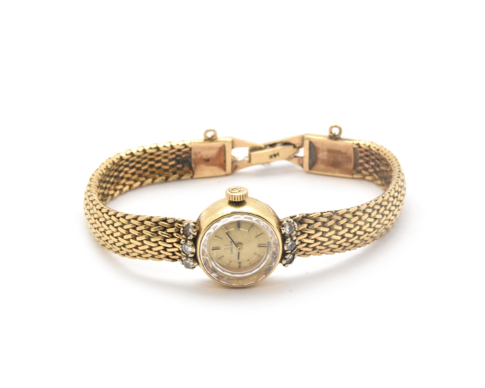 Movement: manual wind 
Function: hours, minutes
Case: 17mm 14k yellow gold case, acrylic crystal, diamonds on case = 0.30cttw
Band: 14k yellow gold bracelet with integrated clasp, fits up to a 6.5-inch wrist
Dial: champagne dial, black hands, gold