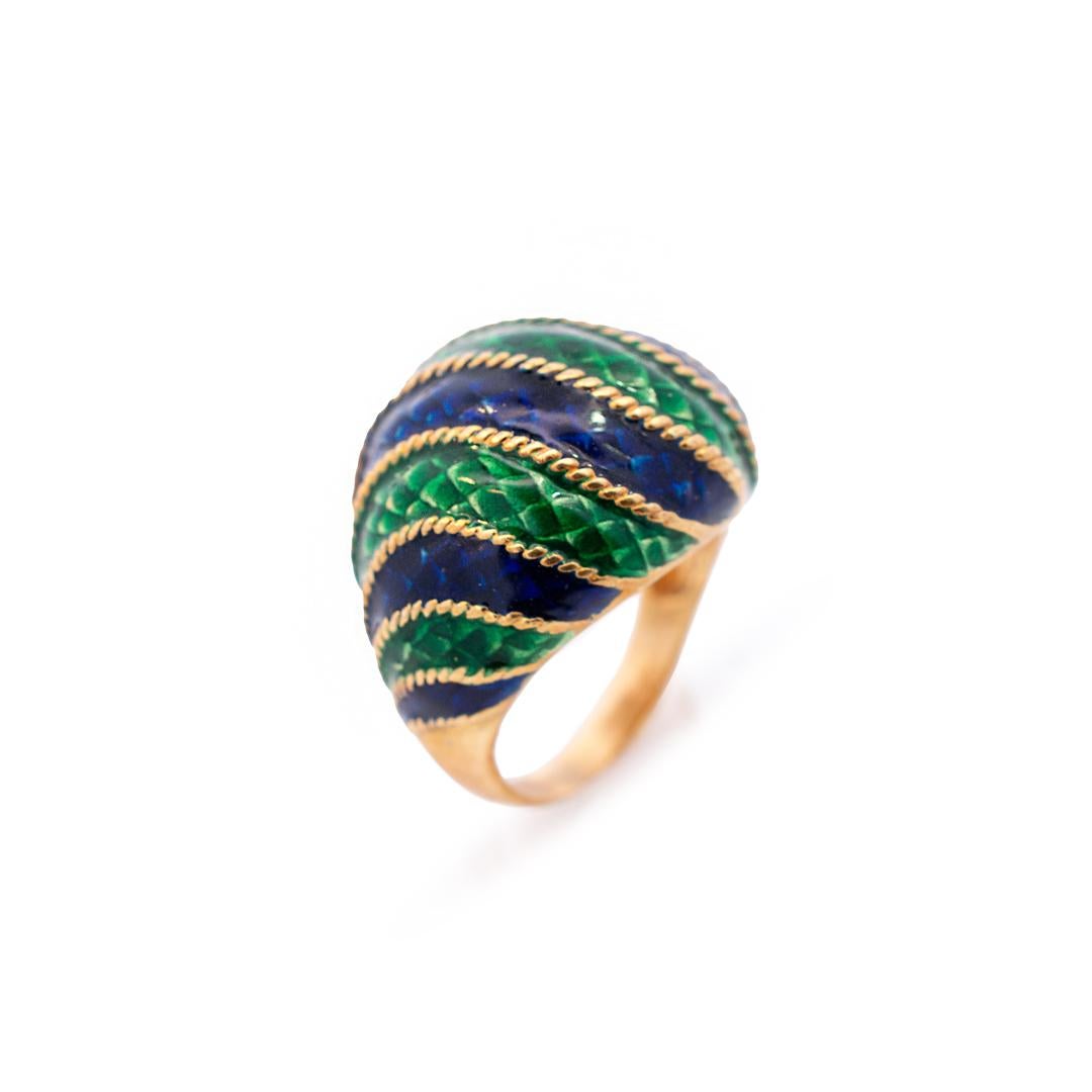 Gender: Ladies

Metal Type: 18K Yellow Gold

Ring Size: 4.5

Total weight: 8.75 grams

Shank Width: 2.80mm

Head measurements: 22.40mm x 17.95

Handmade vintage 18K yellow gold and blue & green enamel with a tapered shank.

Pre-owned in very good
