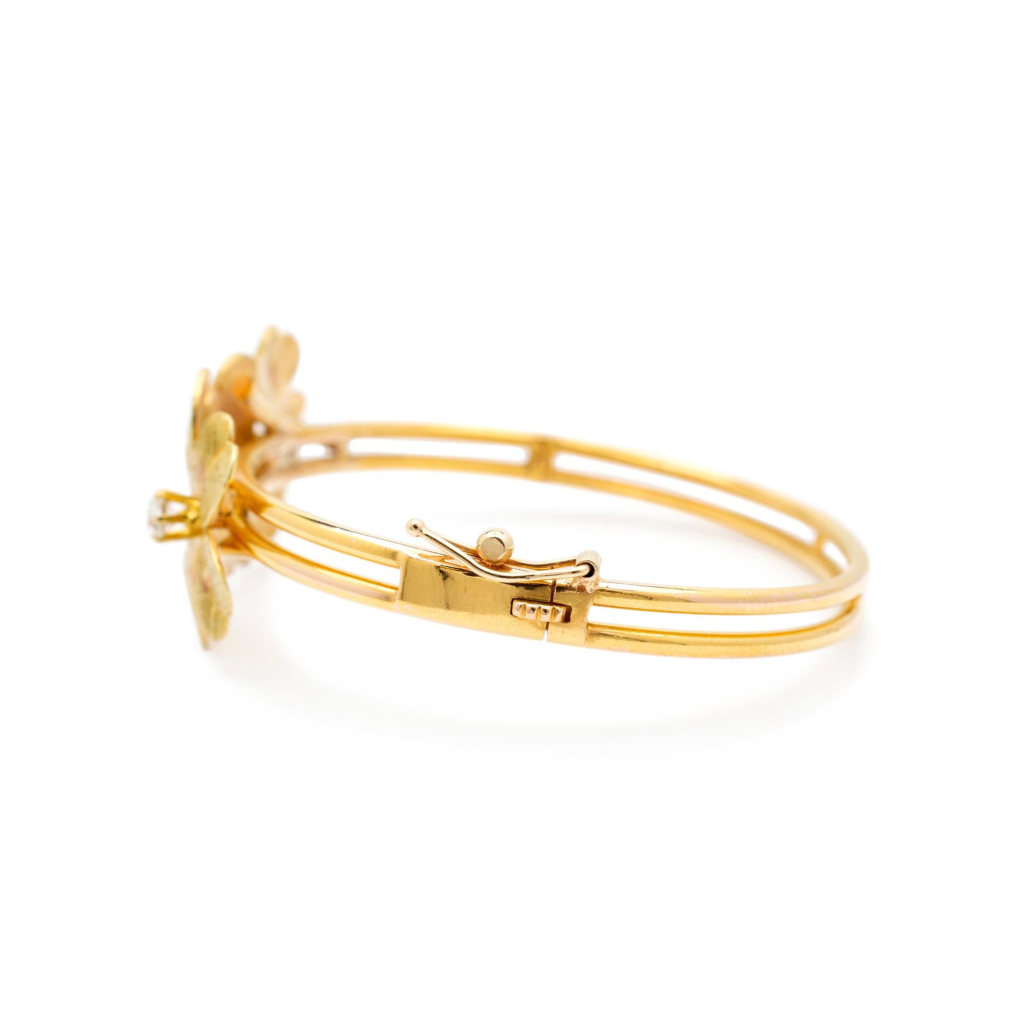 Gender: Ladies

Metal Type: 18K Yellow Gold

Length: 5.75 Inches

Band Width: 4.50 mm

Weight: 18.68 grams

Ladies 18K yellow gold diamond bangle bracelet.  Flower decoration measures 20.30mm in width.

Pre-owned in excellent condition. Might shows