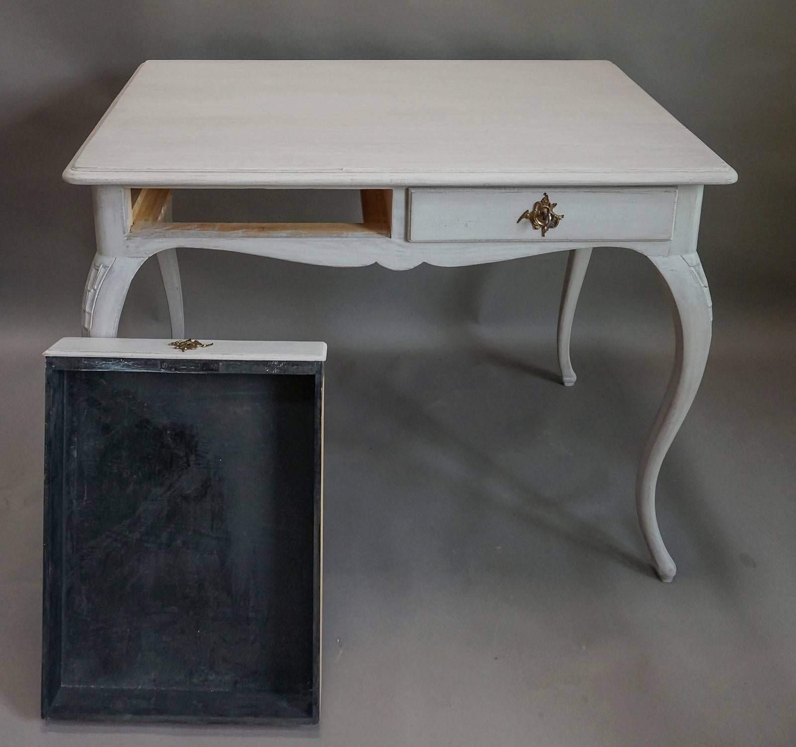 Graceful writing desk, Sweden, circa 1920, with two apron drawers and delicate cabriole legs with carving on the knees.