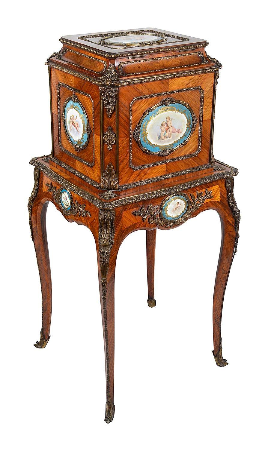 An early Victorian porcelain and ormolu mounted rosewood and tulipwood jewellery coffer on stand or coffre a bijoux attributed to Johann Martin Levien (1811-1871)
Circa 1845, an identical model forms part of the Royal Collection
The quarter veneered