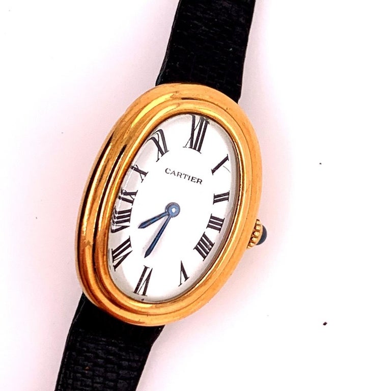 Ladies Yellow Gold Cartier Baignoire Paris Watch & Buckle. 

Mechanical Hand Winding Movement. Watch is working, do NOT overwind the mechanical movement.

Case Height is 31.5mm, Case Width is 22.5mm, Case Thickness 7.3mm

With strap watch is 8