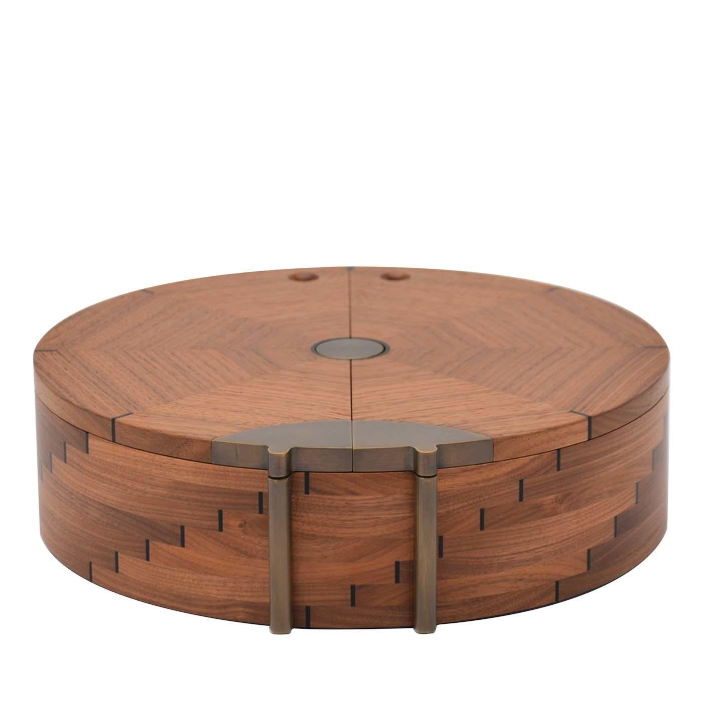 This charming box is handcrafted of walnut with a shape inspired by the ladybug, symbol of good fortune and prosperity. The round base showcases dovetail-joint inserts of ebony that form an eye-catching geometric pattern of ascending stairs. The lid