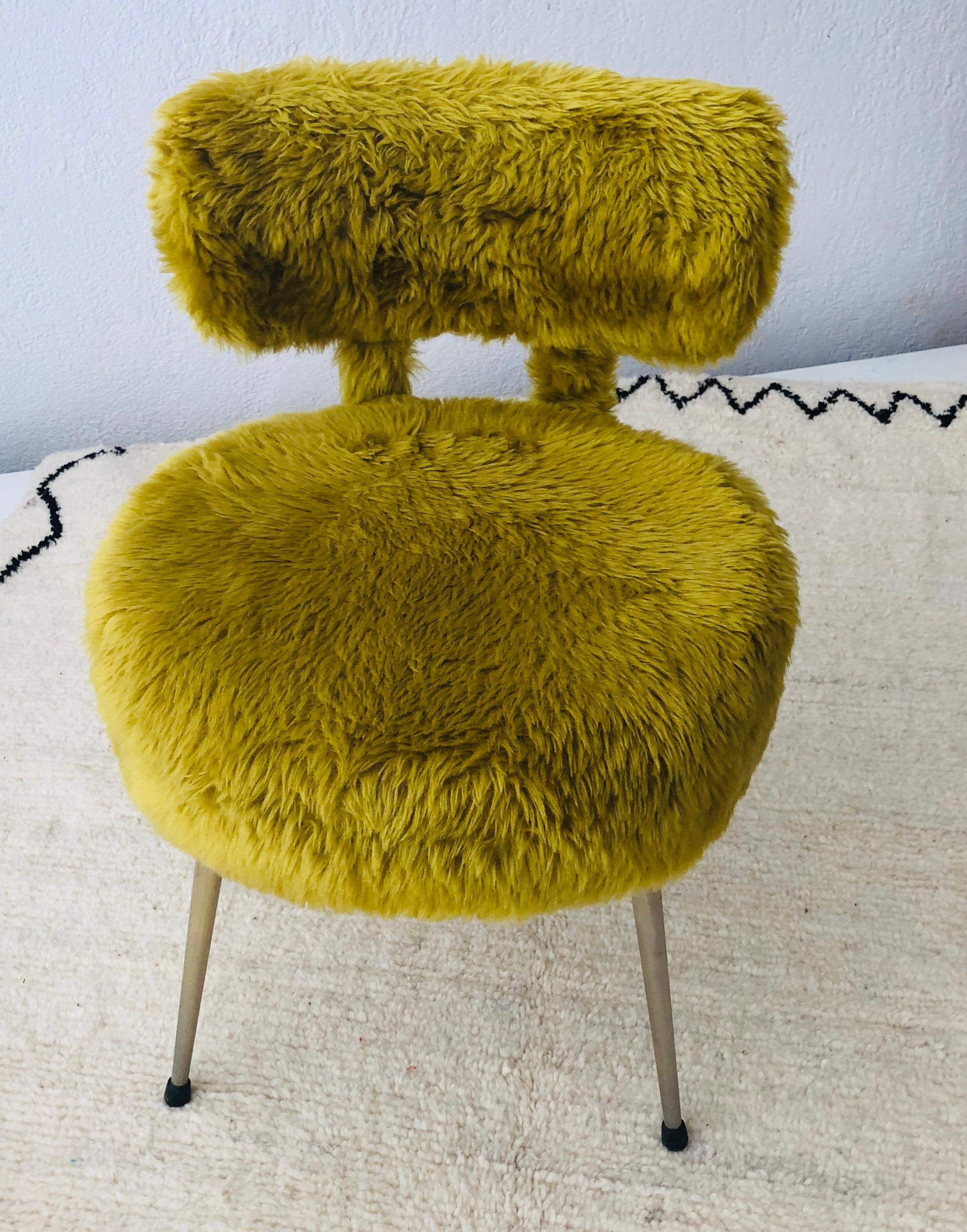 Mid-Century Modern 

This petite lady chair is made of sheep wool and very comfortable as well as stylish. The iron legs and the overall chic design ion the chair is a clean and uniquely design of the Mid-Century Modern era

Dimension: 18 by 18