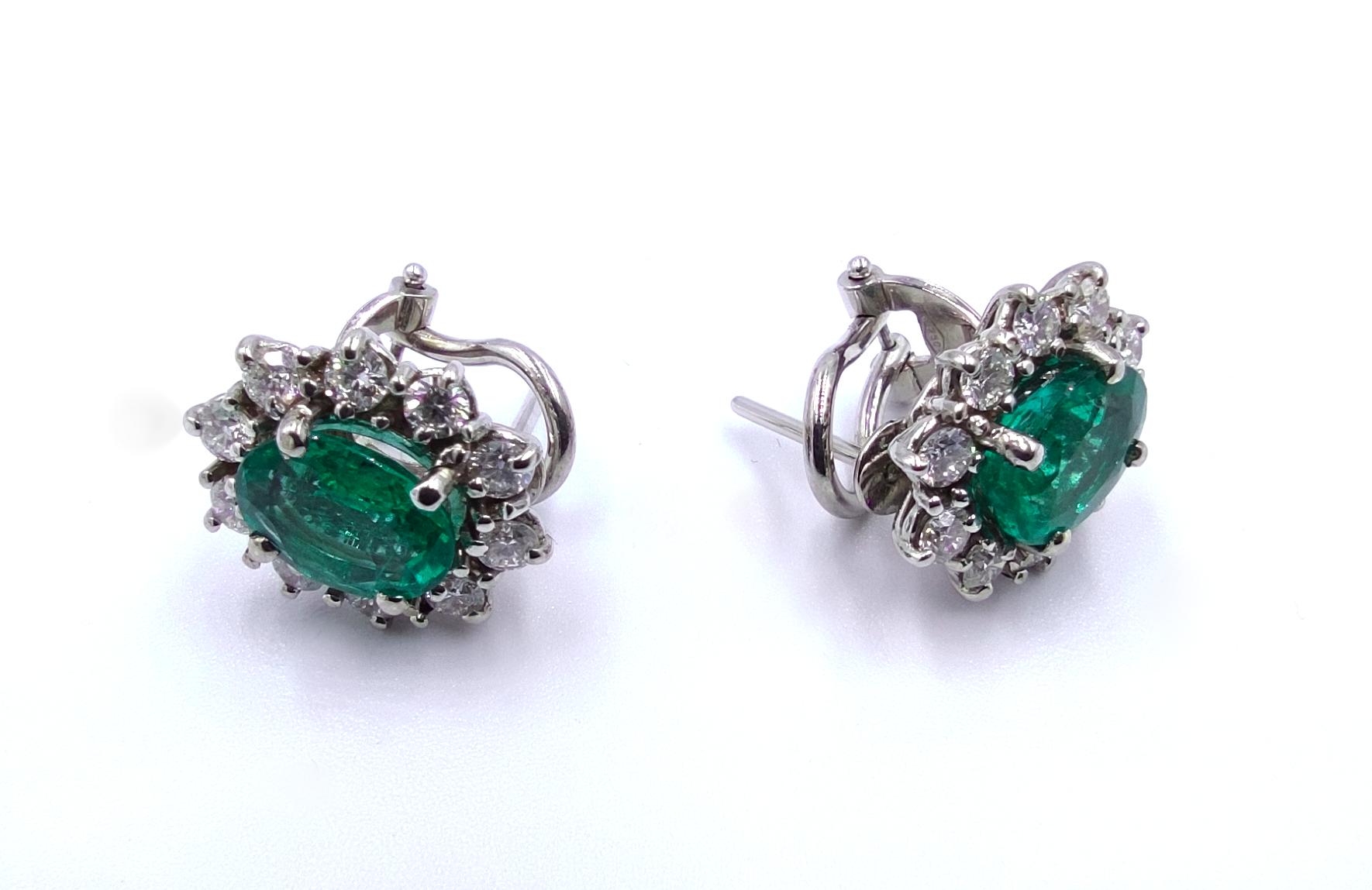 Lady D Green Emerald Round Brilliant Cut with Diamond Halo Stud Earrings set on 18Kt White Gold 
Handmade in Italy in solid 18 Carats White Gold
1 Carat of VS Clarity G Color Diamonds
the emeralds are natural and have a very nice green tone they