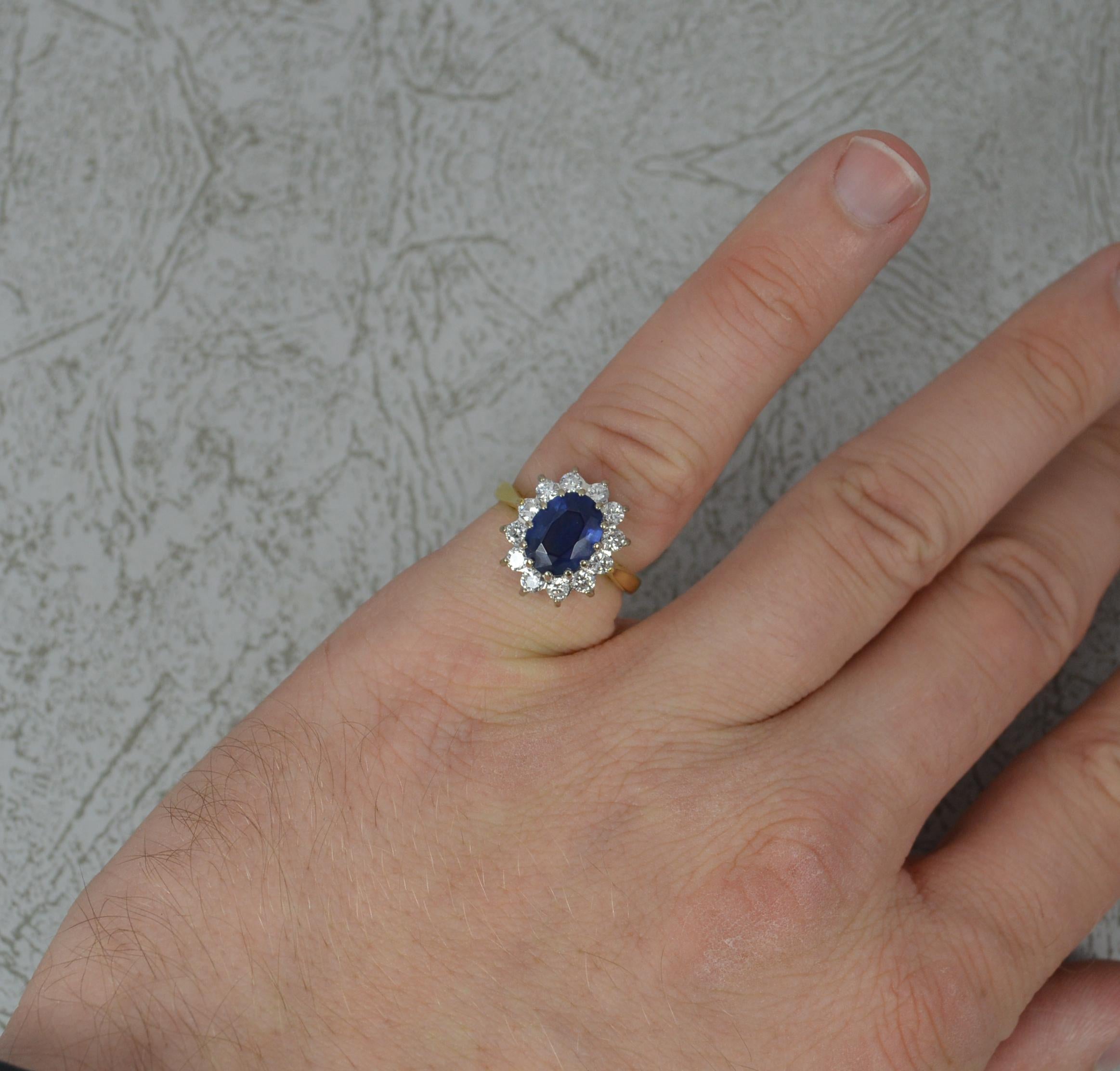 A beautiful Sapphire and Diamond ring.
Solid 18 carat yellow gold shank and white gold head.
Designed with a sapphire to the centre of superb dark clear blue colour with full border of 12 natural round cut diamonds in white gold claw head setting.