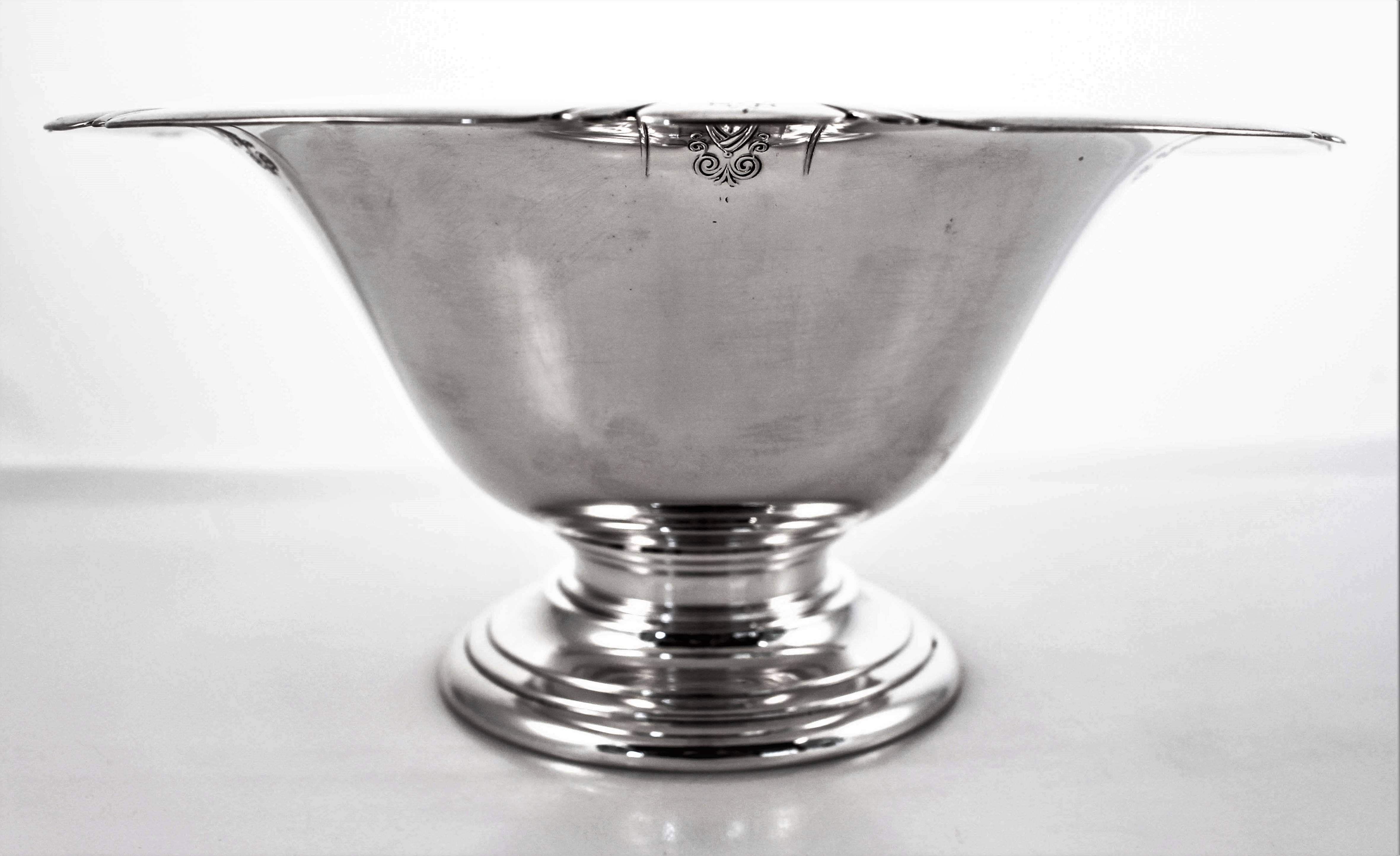 This Art Deco bowl has a scalloped rim and sits on a pedestal — not weighted. There are six etched designs evenly dispersed around the lip of the bowl. Several swirls and oval cartouche compliment the scalloping. It has a nice deep centre that makes