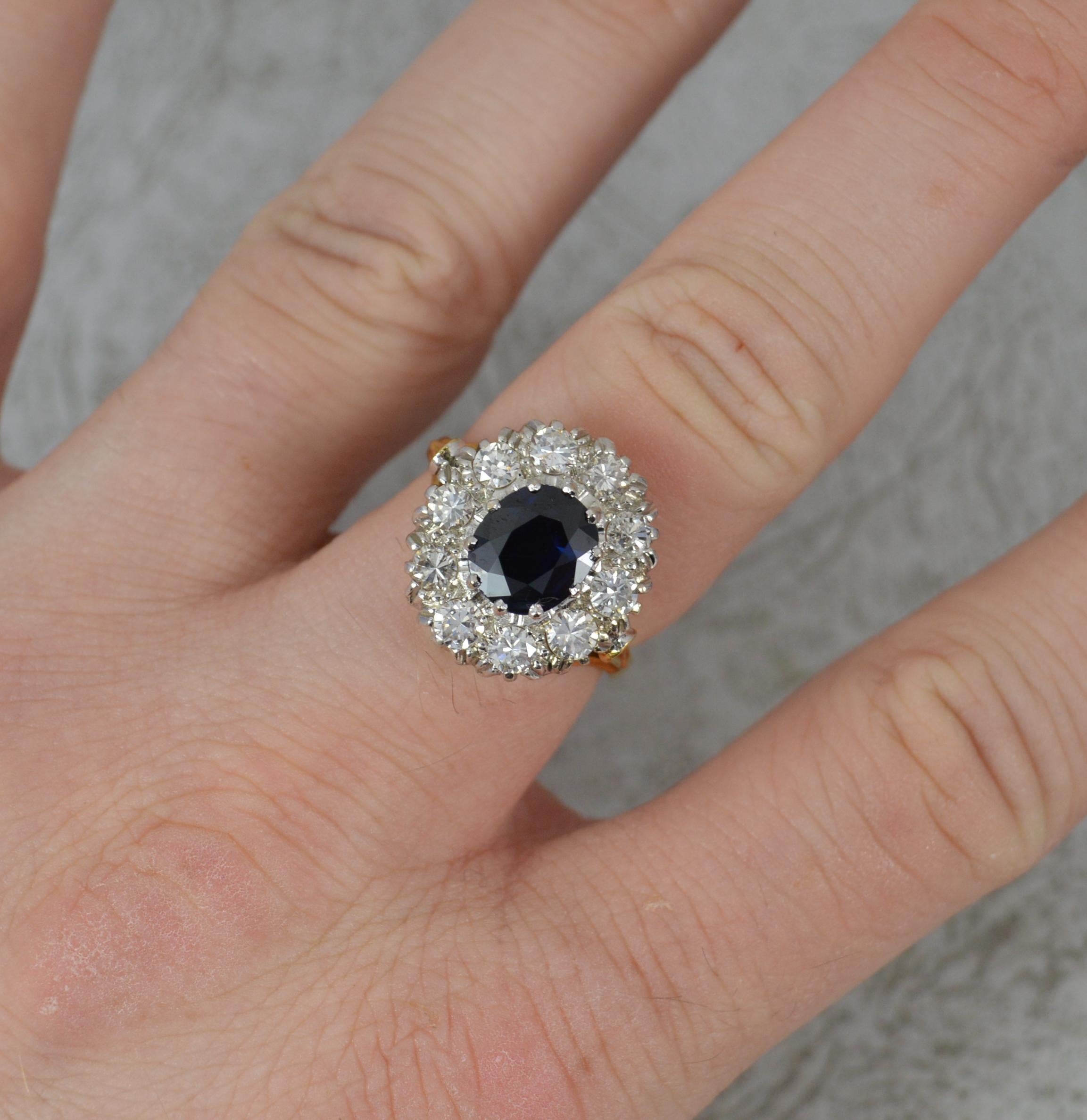 A beautiful Sapphire and Diamond ring.
Solid 18 carat yellow gold shank and platinum head setting.
Designed with a natural dark blue sapphire to the centre, 7.1mm x 8.25mm in multi claw setting. Surrounding are ten natural round cut diamonds to