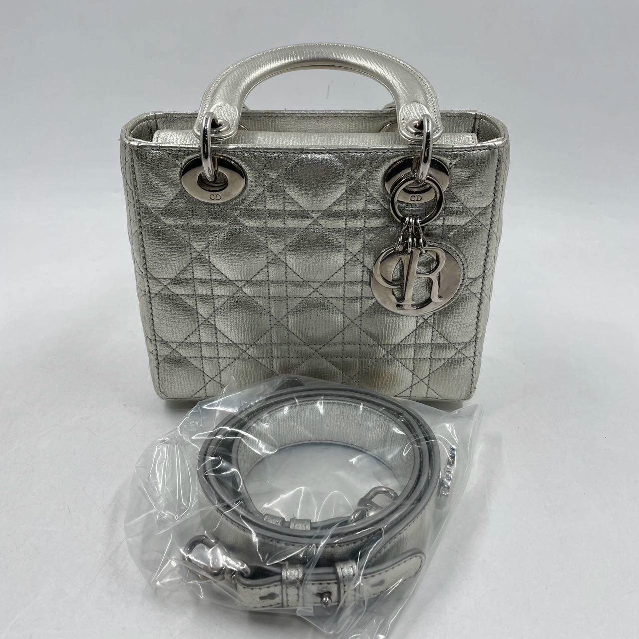 Introducing the Lady Dior ABCdior Small Silver Cannage Lambskin Handbag. Its ABCdior my lady dior design, space silver color, and studded strap make it the epitome of elegance. Plus, its cool color and most popular size make it a must-have accessory