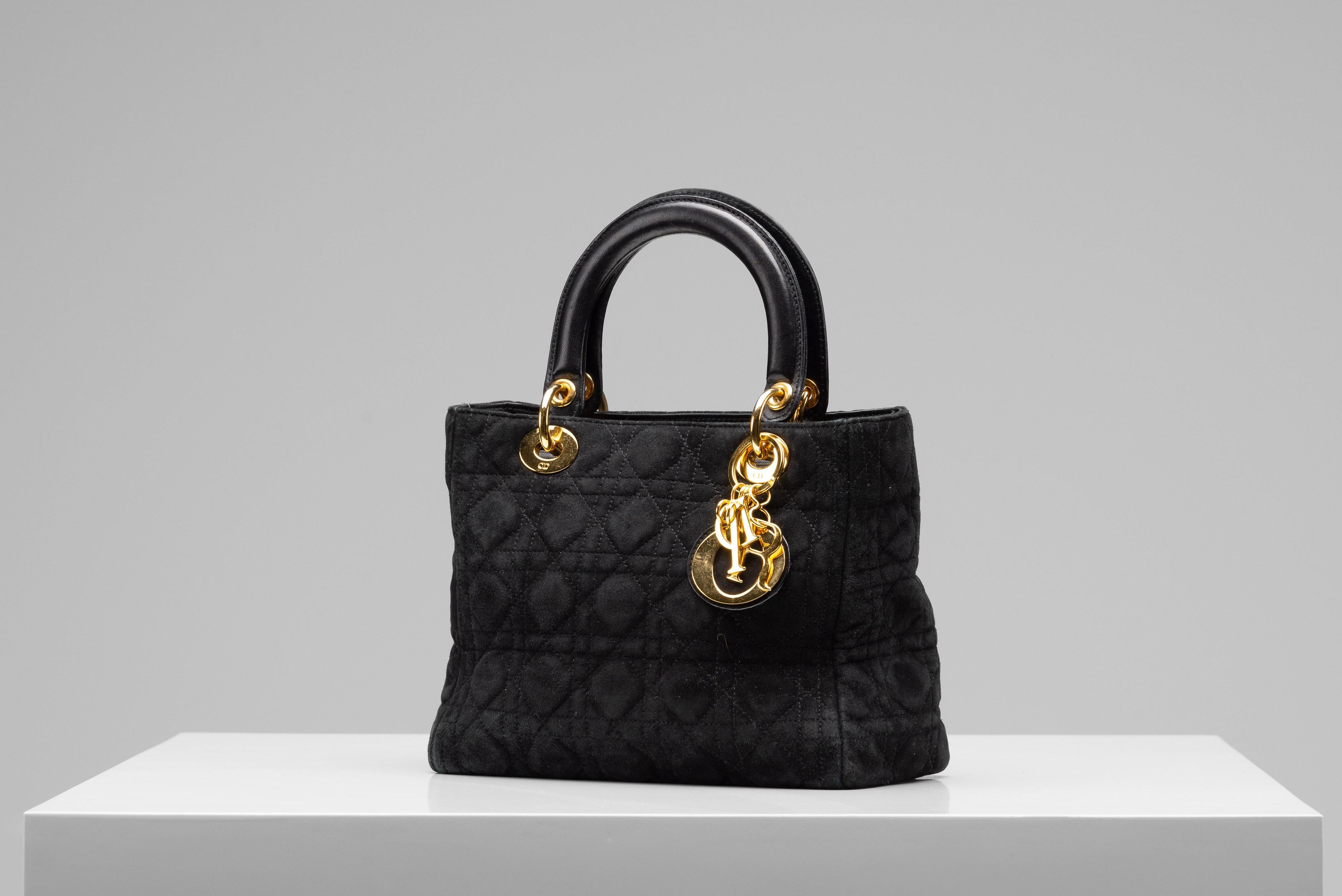 From the collection of SAVINETI we offer this Lady Dior Bag:
- Brand: Dior
- Model: Lady Dior Suede Vintage
- Color: Black
- Materials: suede, gold hardware
- Condition: good vintage condition

Authenticity is our core value at SAVINETI and this