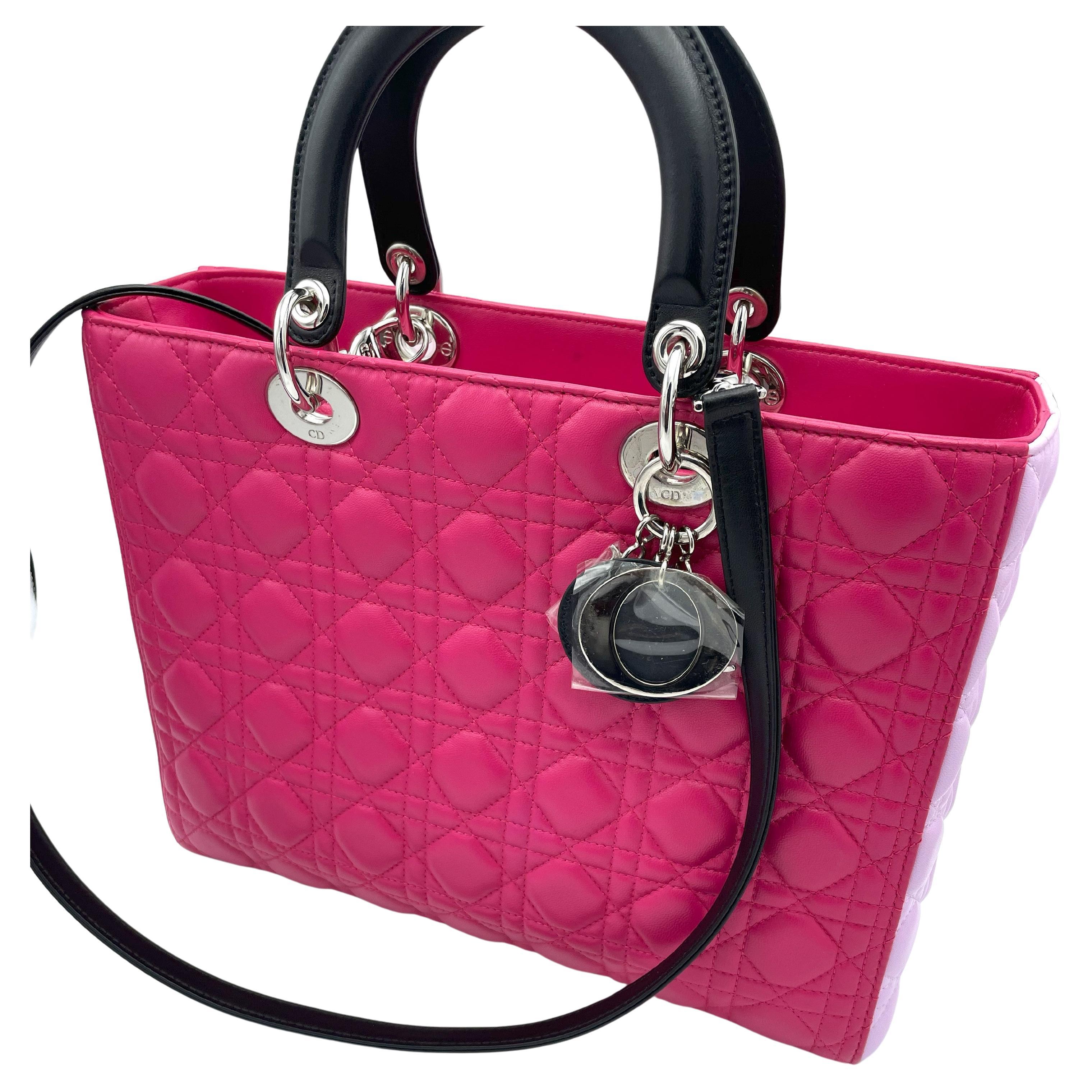Large LADY DIOR BAG, lila, pink and black calfskin cannage leather with silver metal trim and  black 90 cm x 1,5 cm long removable  shouder strap. Lined with black leather and with a side pocket with Zipper.

Dimensions 
Width     32 cm 
Height   25
