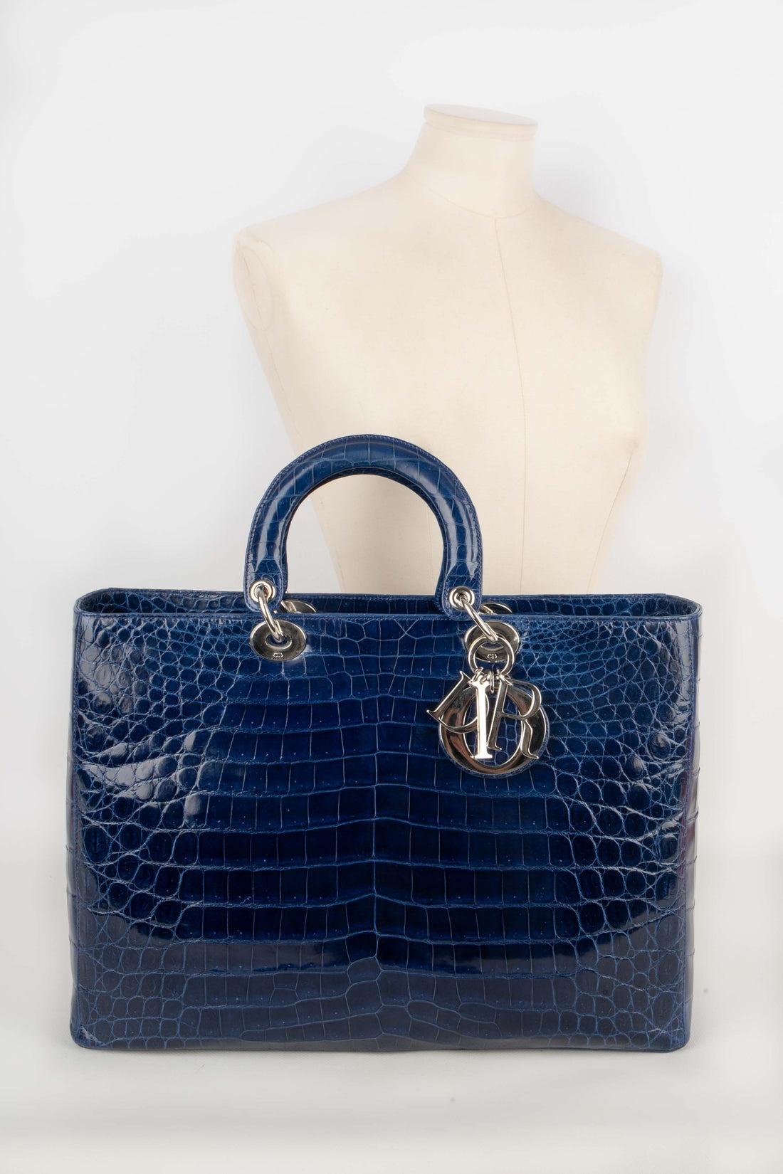 Dior -  (Made in Italy) Large 'Lady Dior' bag made of sapphire Crocodylus Niloticus leather. Bag with a zip and a double handle with one holding alphabet charms in the House name. Leather inside lining. A 2009 Limited Edition.

Additional