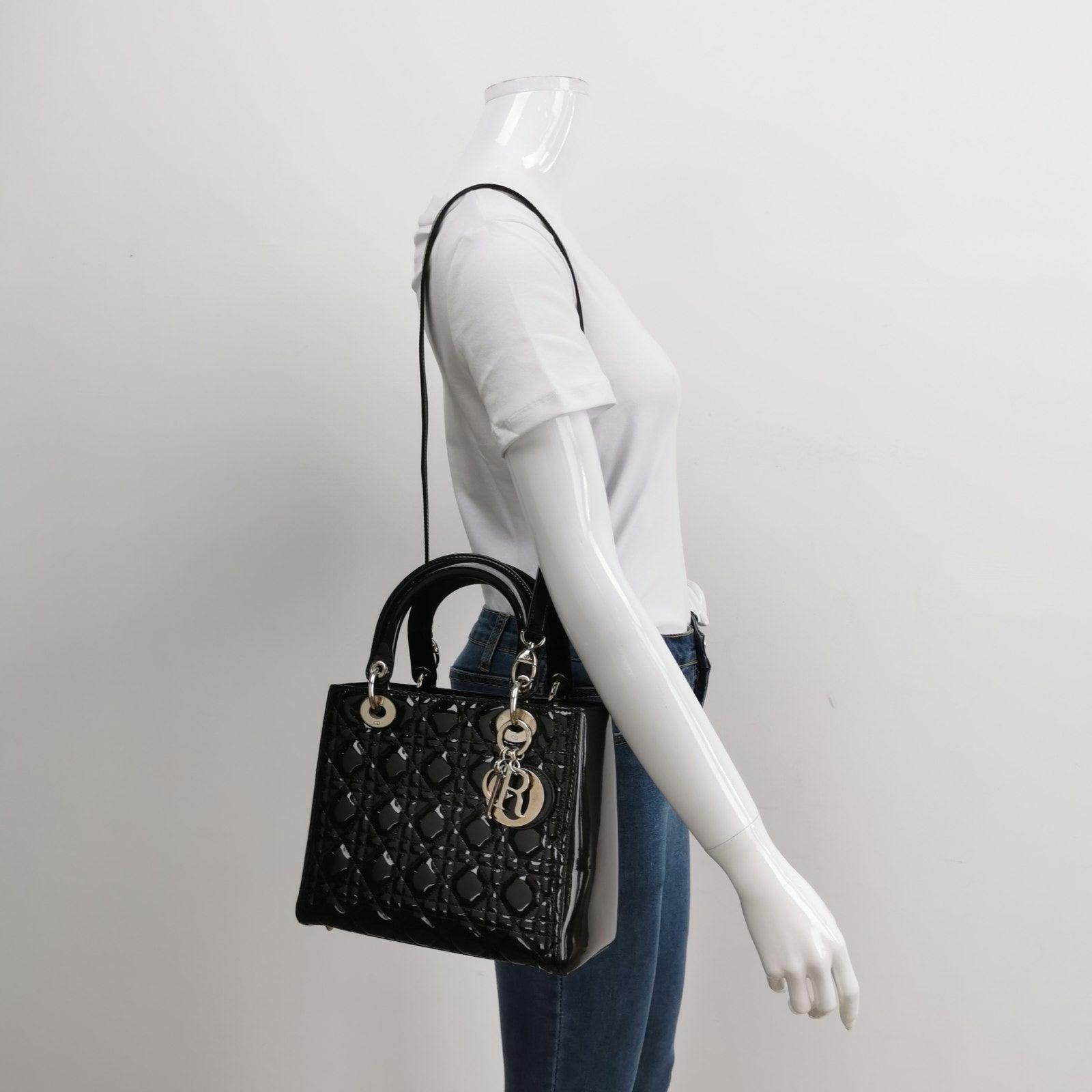 Lady Dior Medium Black Patent Leather Handbag with Silver Hardware
  These are professional photos of the actual bag.
  The Lady Dior bag is an epitome of elegance and beauty. Accentuate your look with the timeless style of Medium Lady Dior, crafted