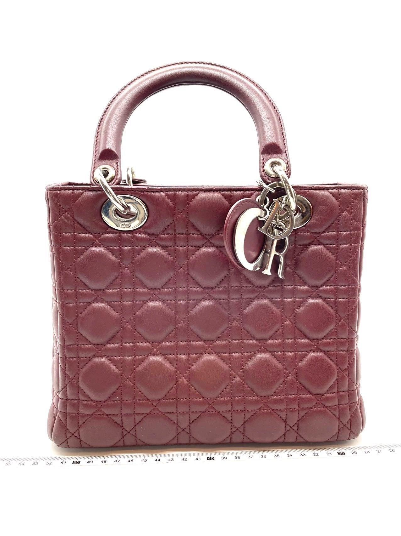 Lady Dior Medium Burgundy Cannage Lambskin Leather with strap
 These are professional photos of the actual bag offered by Luxbags.
 The Lady Dior bag is an epitome of elegance and beauty. Accentuate your look with the timeless style of Medium Lady