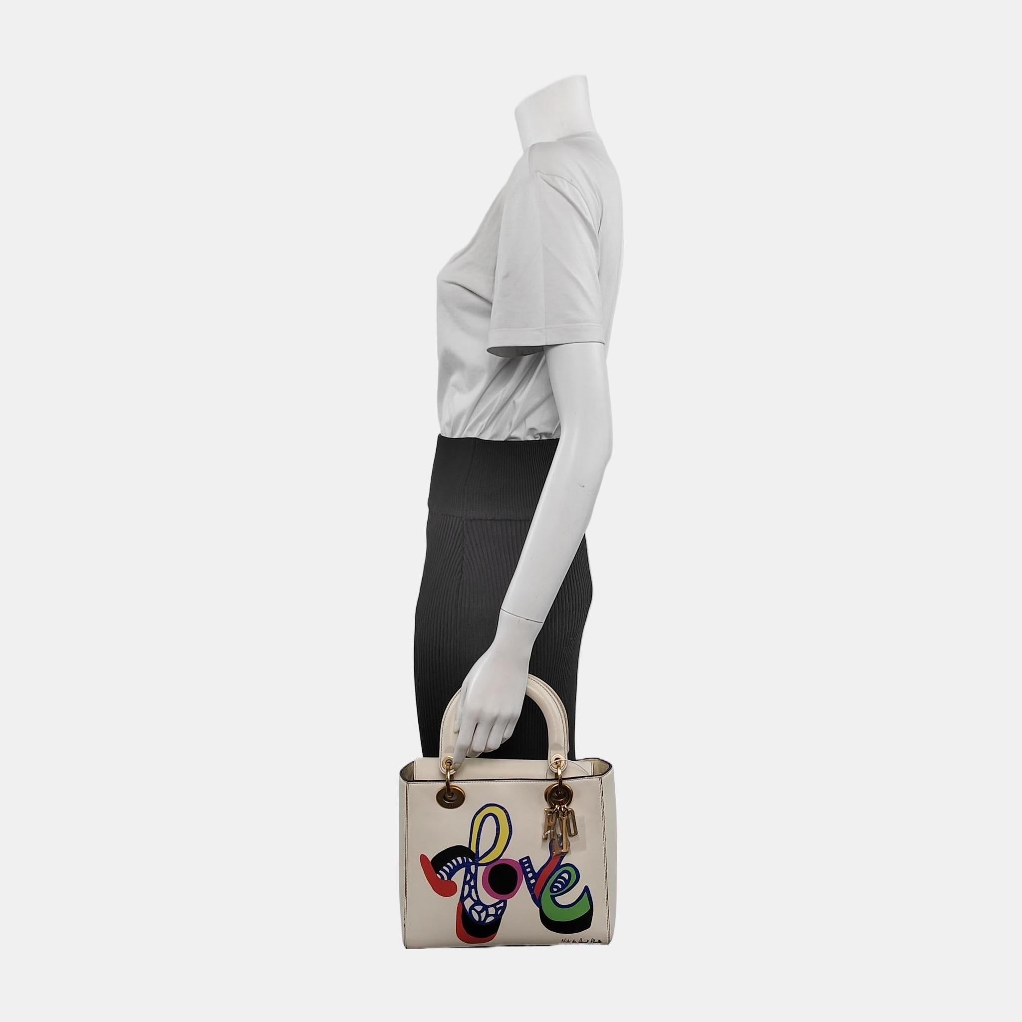 The Lady Dior bag is an epitome of elegance and beauty. Accentuate your look with the timeless style of Medium Lady Dior, crafted in Beige Patent Leather. This classic bag features a cannage stitch, creating a beautiful silhouette, and an instantly