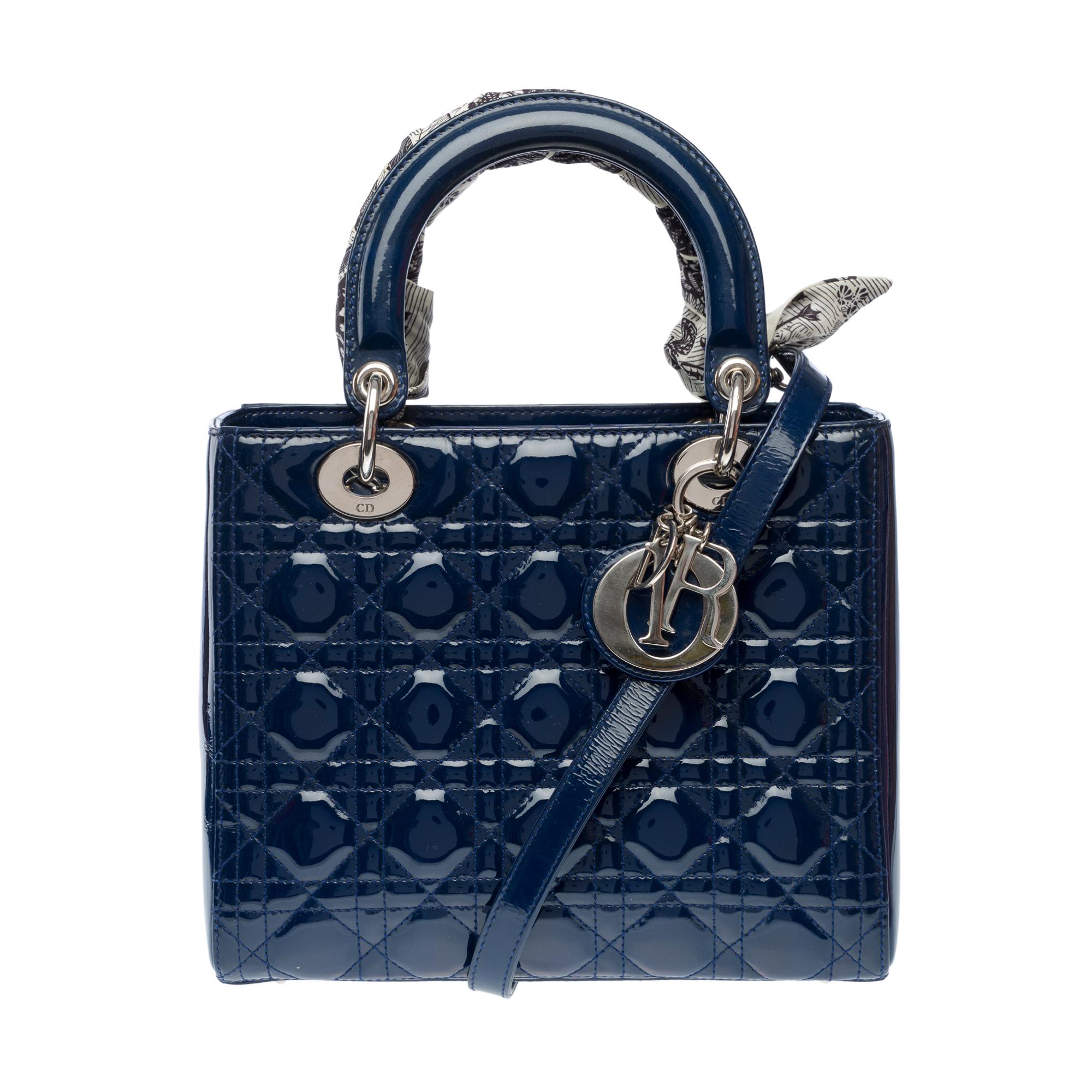 Very​ ​chic​ ​Dior​ ​Lady​ ​Dior​ ​MM​ ​handbag​ ​strap​ ​Medium​ ​(MM)​ ​in​ ​navy​ ​blue​ ​cannage​ ​patent​ ​leather​ ​,​ ​silver​ ​metal​ ​trim,​ ​double​ ​blue​ ​patent​ ​leather​ ​handle,​ ​removable​ ​blue​ ​leather​ ​shoulder​ ​strap​
