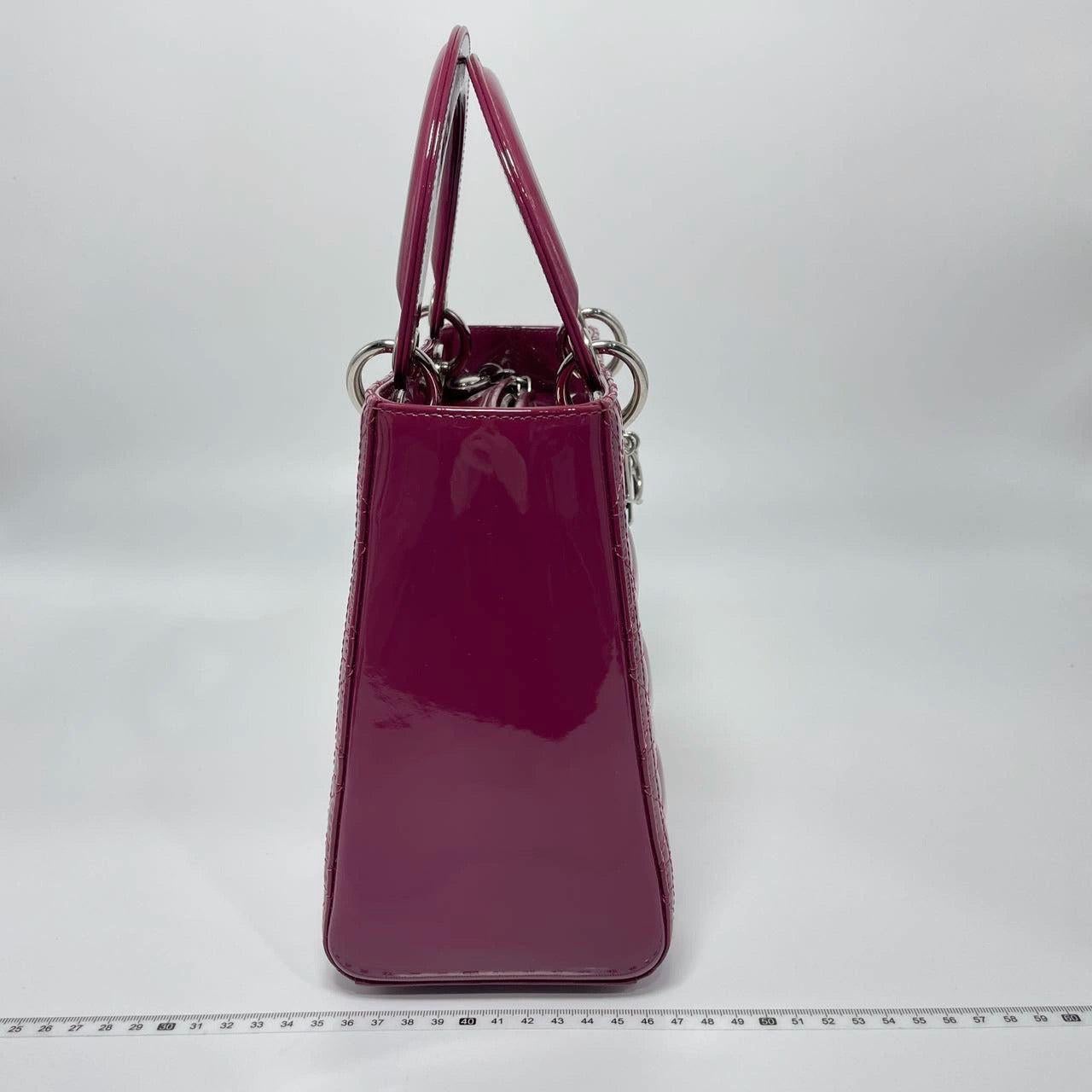 Lady Dior Medium Purple Patent Leather Handbag These are professional photos of the actual bag offered by Luxbags. The Lady Dior bag is an epitome of elegance and beauty. Accentuate your look with the timeless style of Medium Lady Dior, crafted in