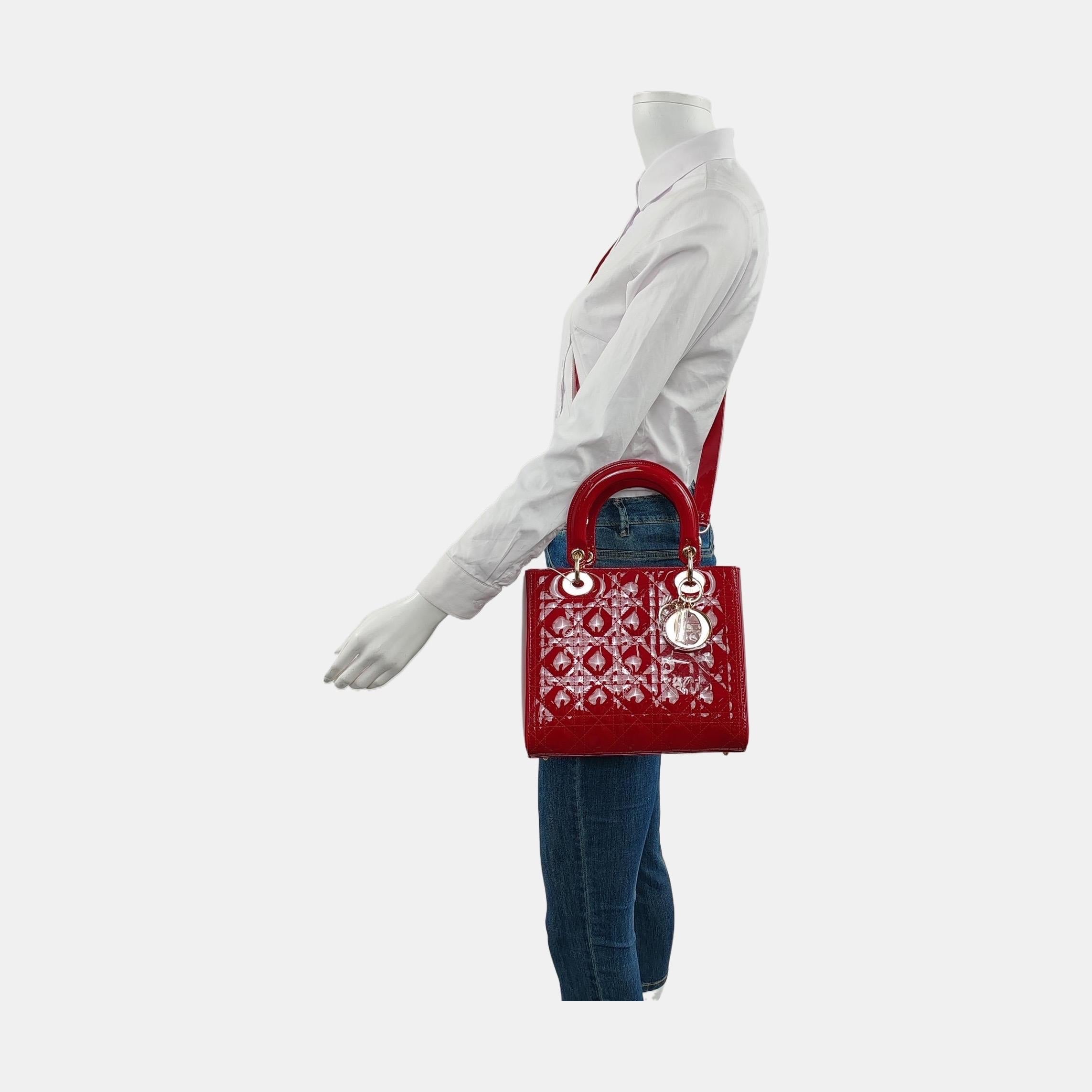The Lady Dior bag is an epitome of elegance and beauty. Accentuate your look with the timeless style of Medium Lady Dior, crafted in Burgndy Patent Leather. This classic bag features a cannage stitch, creating a beautiful silhouette and an instantly