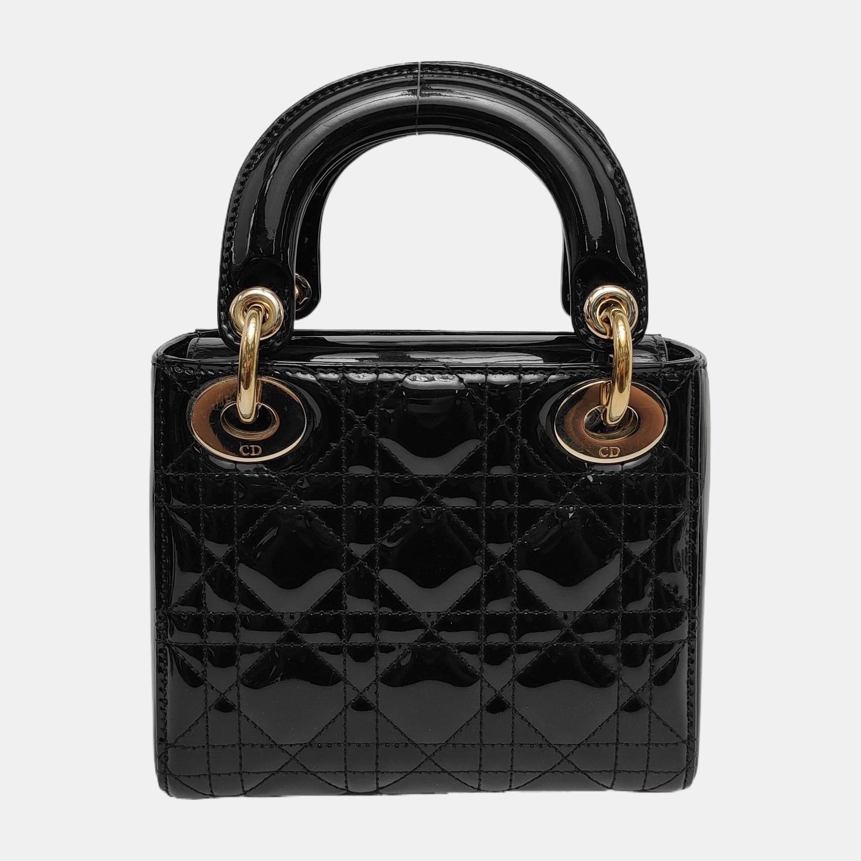 This Lady Dior Mini handbag features a patent leather decorated with gold hardware, making it an ideal accessory for any stylish woman who dares to make a bold statement with their accessory. The mini bag is a cute, yet luxurious addition to your