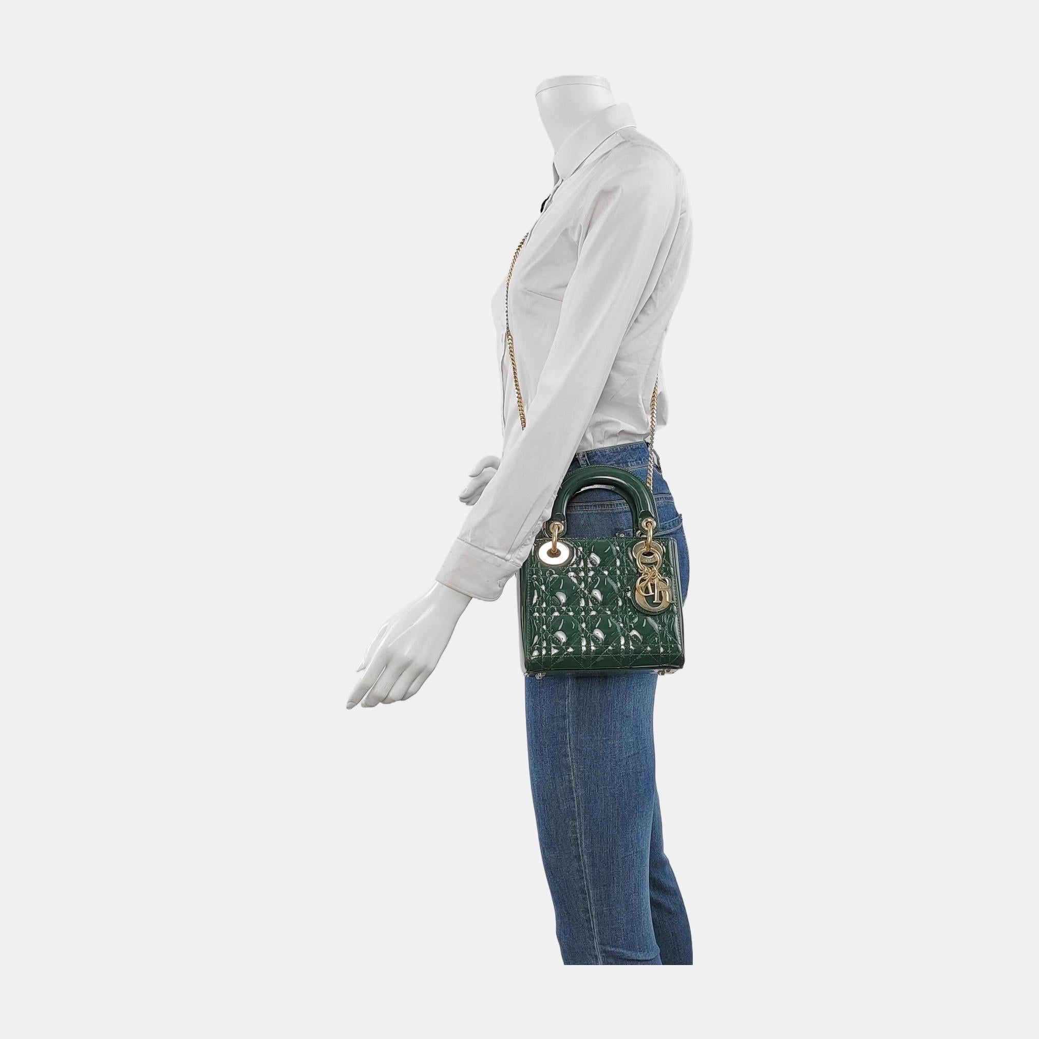 This Lady Dior Mini handbag features a patent leather decorated with gold hardware, making it an ideal accessory for any stylish woman who dares to make a bold statement with their accessory. The mini bag is a cute, yet luxurious addition to your