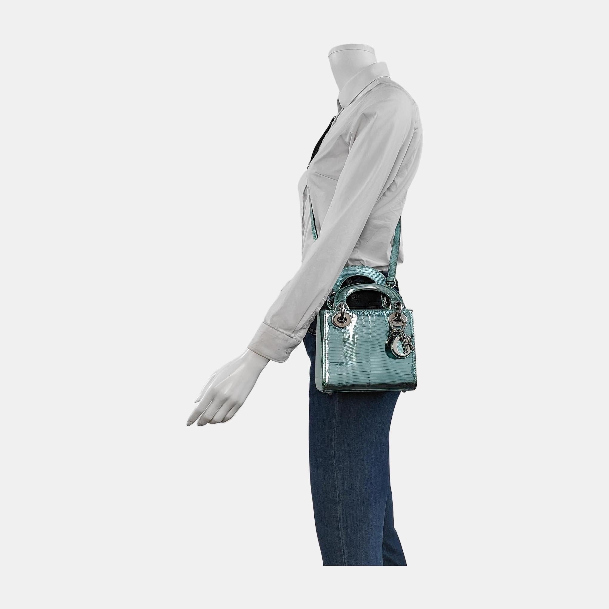 This Lady Dior Mini handbag features an exotic leather decorated with gold hardware, making it an ideal accessory for any stylish woman who dares to make a bold statement with their accessory. The mini bag is a cute, yet luxurious addition to your