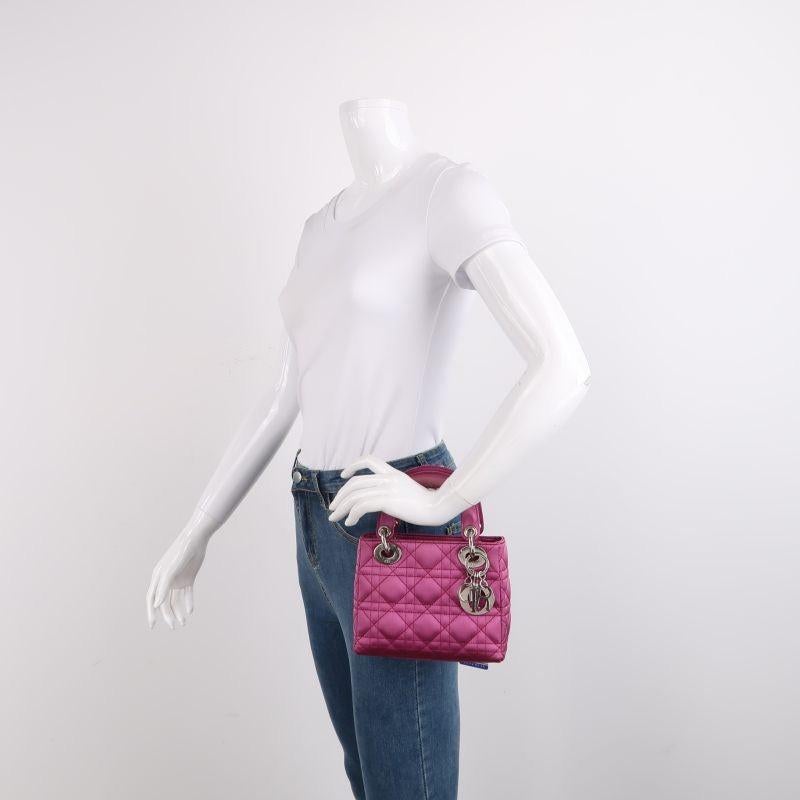 Lady Dior Mini Pink Silk with Silver Hardware
These are professional photos of the actual bag.
This mini handbag, made of high-quality silk satin cloth with iconic micro-cannage stitching, is a stylish and elegant accessory for your wardrobe. It is