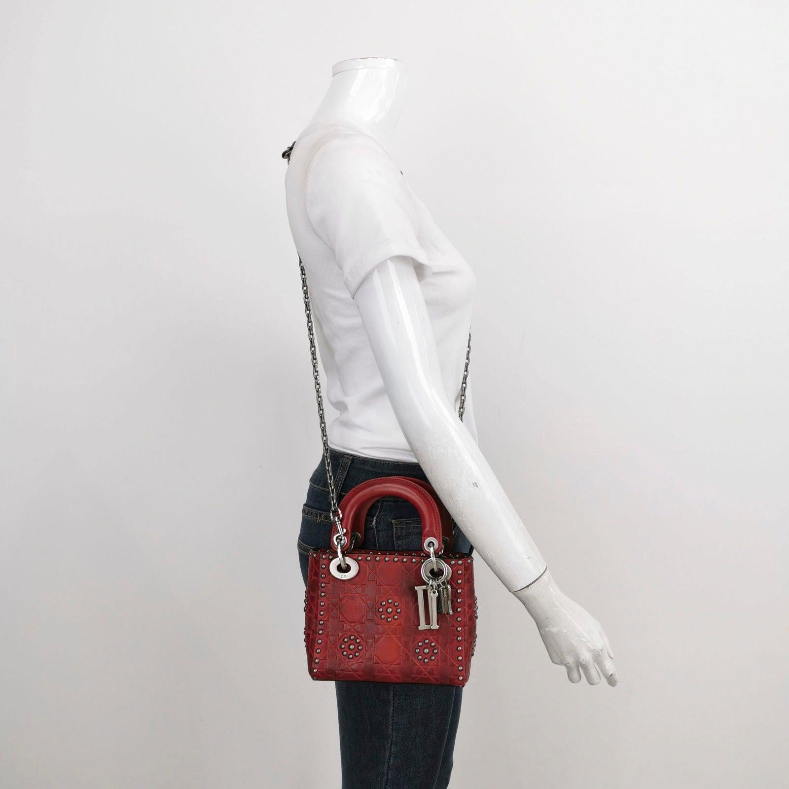 Lady Dior Mini Red Studded Flower Bag 2017 Dior Cruise Collection These are professional photos of the actual bag offered by Luxbags. The Lady Dior Mini Red Studded Flower Bag from the 2018 Dior Cruise Collection is a true statement piece. The