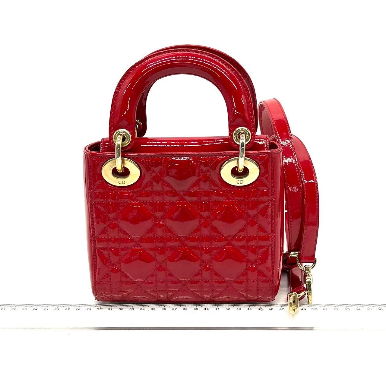 Lady Dior Patent Leather Red Mini handbag with gold hardware
  These are professional photos of the actual bag.
  This Lady Dior Mini handbag features a stunning red color in patent leather decorated with gold hardware, making it an ideal accessory