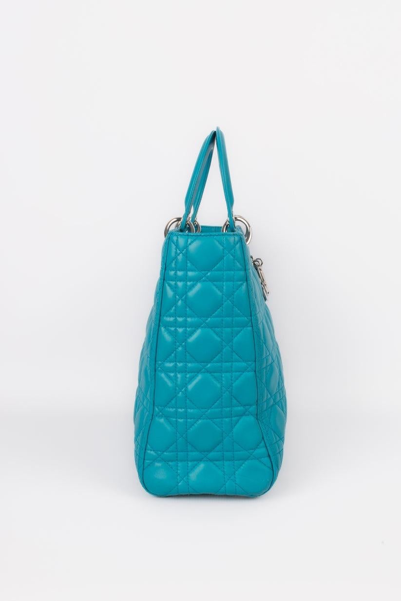 Dior - (Made in Italy) Quilted turquoise blue leather Lady Dior bag with silvery metal elements. Sold with a serial number. 2013 Collection.

Additional information:
Condition: Very good condition
Dimensions: Length: 31 cm - Height: 26 cm - Depth: 9