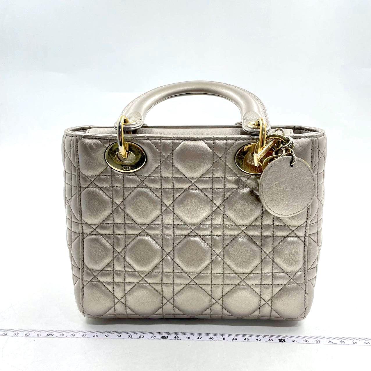 Lady Dior Small ABCdior Light Copper Gold Cannage Lambskin Handbag with ABC Strap
 These are professional photos of the actual bag offered by Luxbags.
 Introducing the Lady Dior ABCdior Light Gold Cannage Lambskin Handbag. 
 This ABCdior beauty in