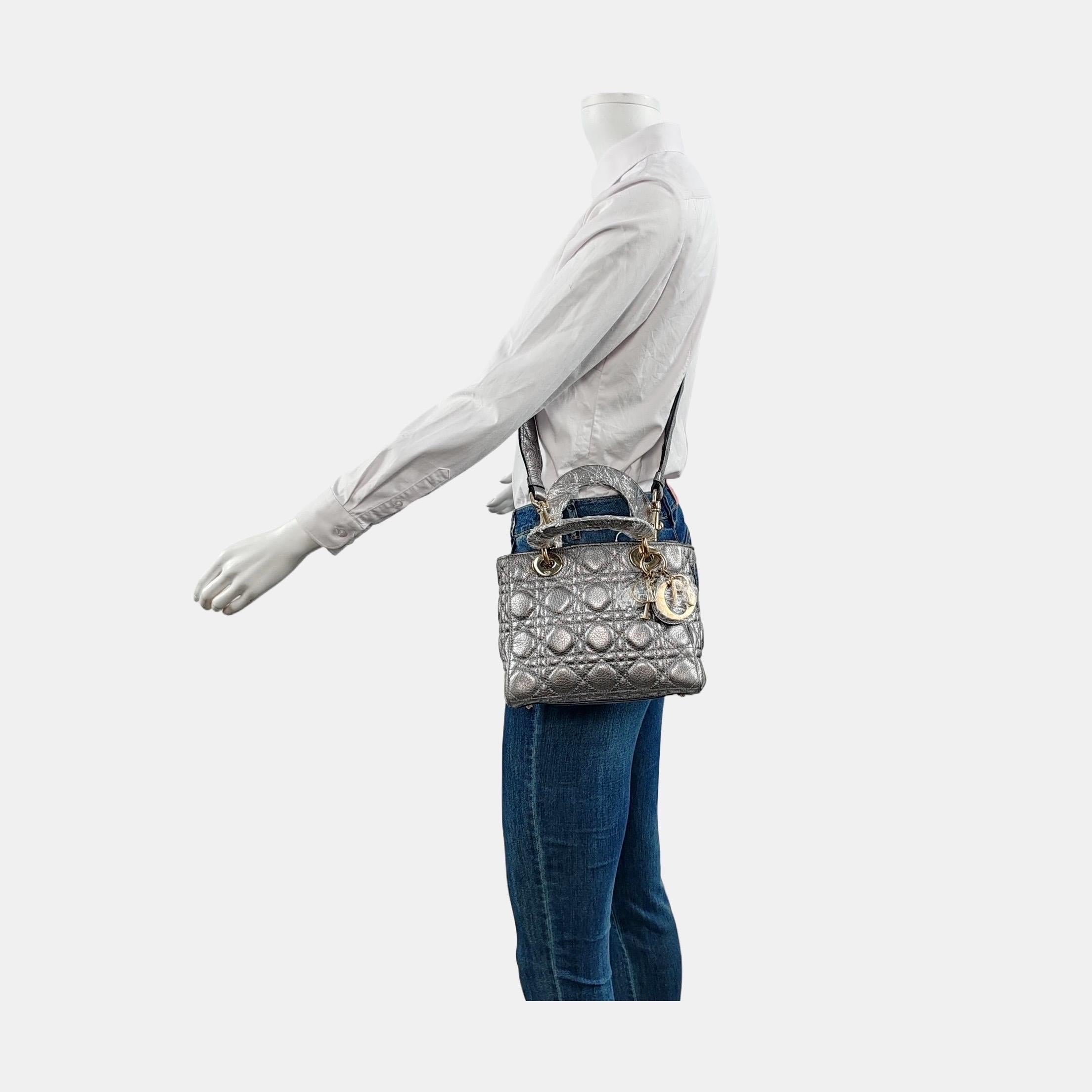 This Lady Dior Mini Supple Calfskin Leather Cannage Handbag with Strap is crafted from supple calfskin leather and features a unique cannage stitch. Unlike the iconic Lady Dior, this version has a more casual look due to its intentionally
