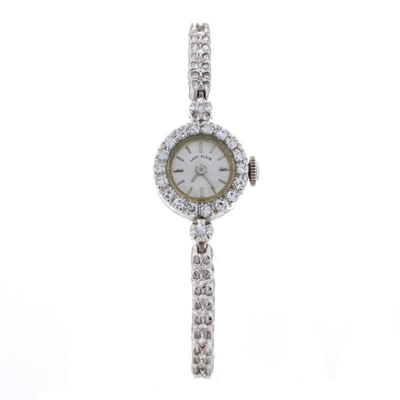 Era: Vintage
Year: 1950s - 1960s
Brand: Lady Elgin
Dial Color: Silver
Metal Content: 14k White Gold 
Movement: Mechanical
Number of Jewels: 17
Warranty: One-Year

Stone Information
Natural Diamonds
Total Carats: 1.36ctw
Cut: Single
Color: F -