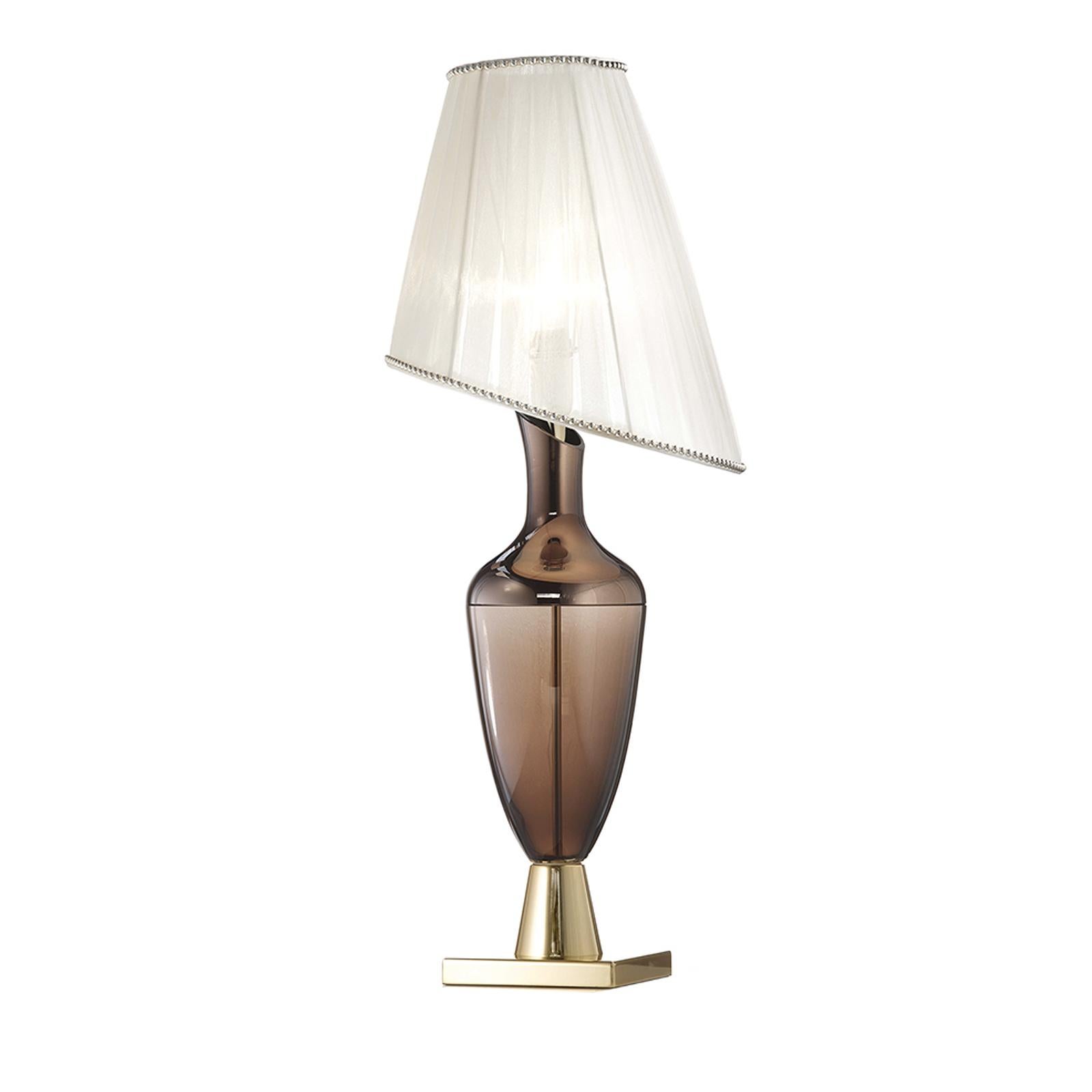 Part of the Lady collection, this elegant and modern table lamp will make a statement in an entryway, a living room, and even a bedroom atop a nightstand. Its asymmetrical lampshade screens a single E27 x 60W lightbulb, supported by an exquisite