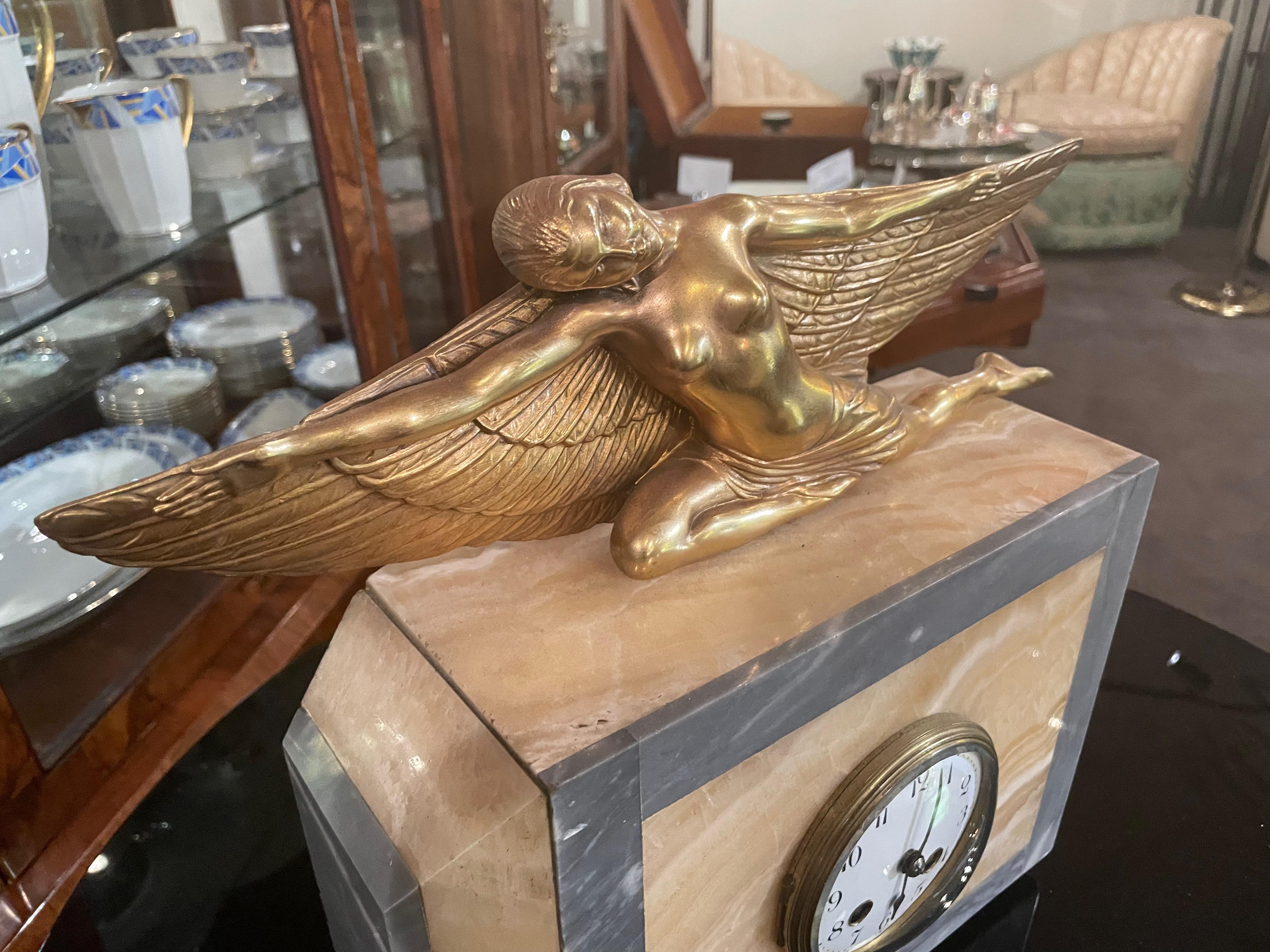 Mid-20th Century Lady Icarus Gilded Art Deco Statue Adorns Marble French Clock For Sale
